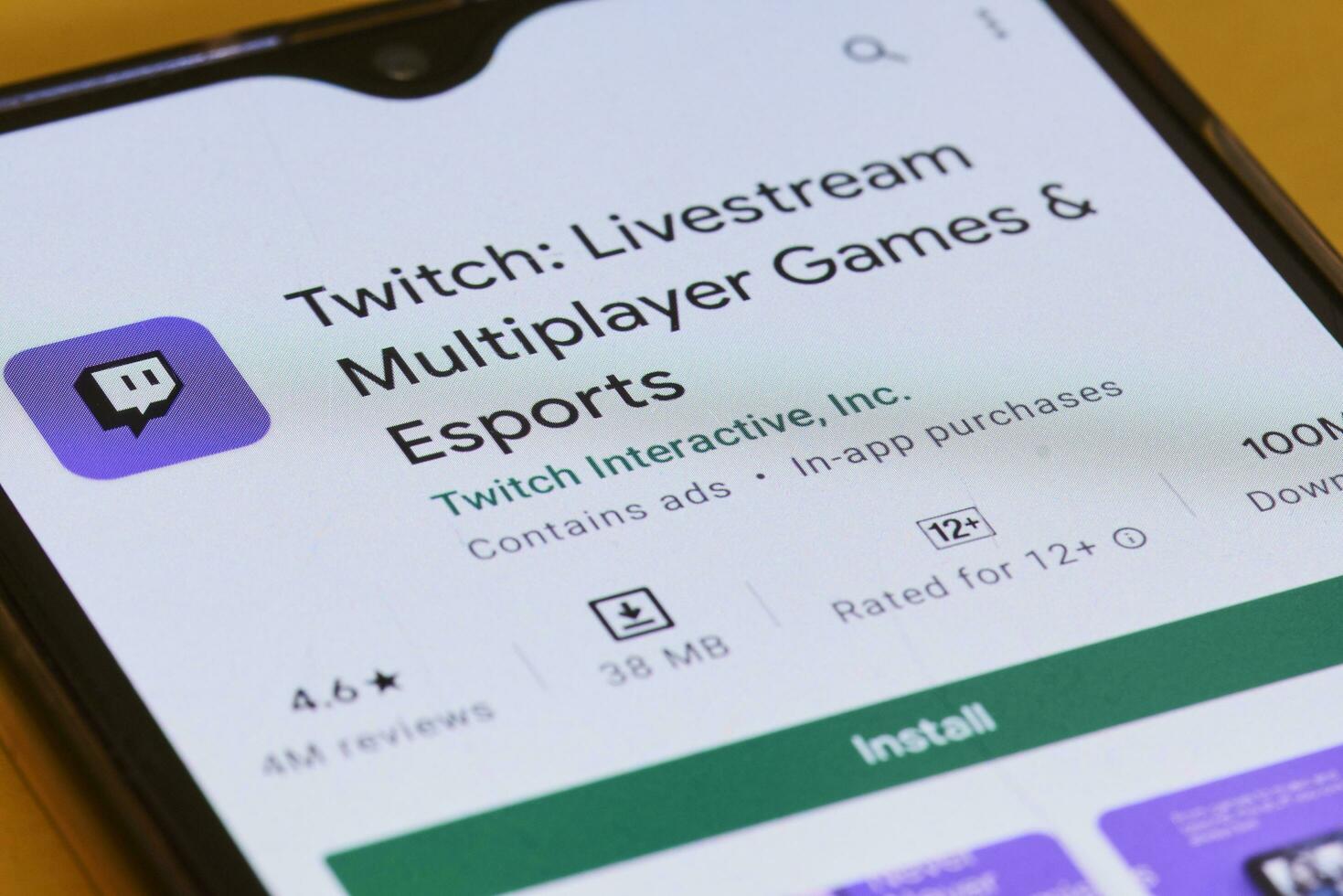 Searching and downloading Twitch application to smartphone photo