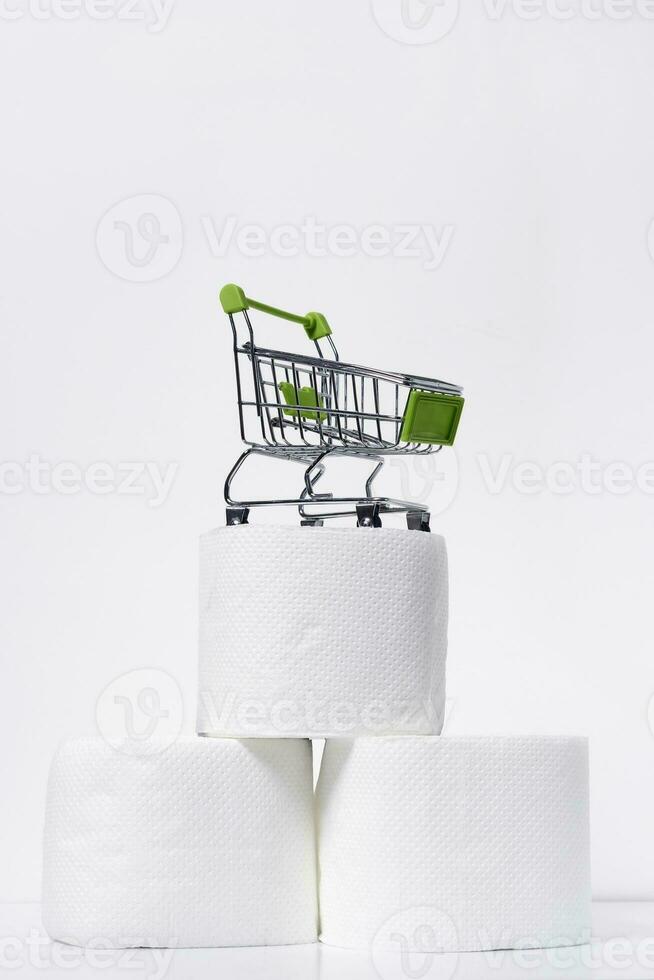 Three rolls of toilet paper and a cart photo