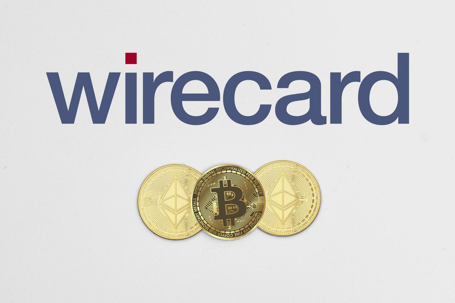 Bitcoin and ethereum cryptocurrency coins on Wirecard logotype photo