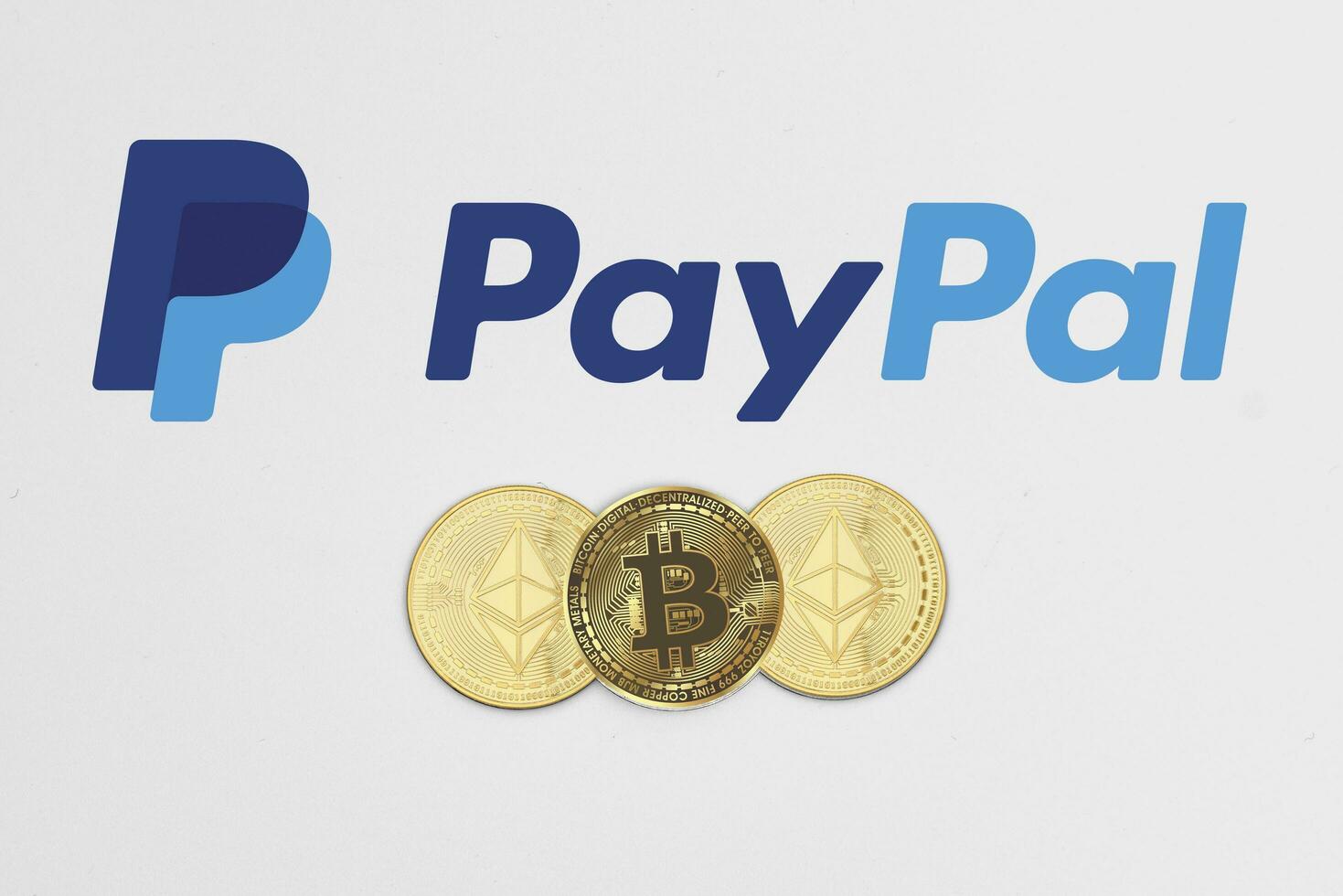 Bitcoin and ethereum cryptocurrency coins on Paypal logotype photo