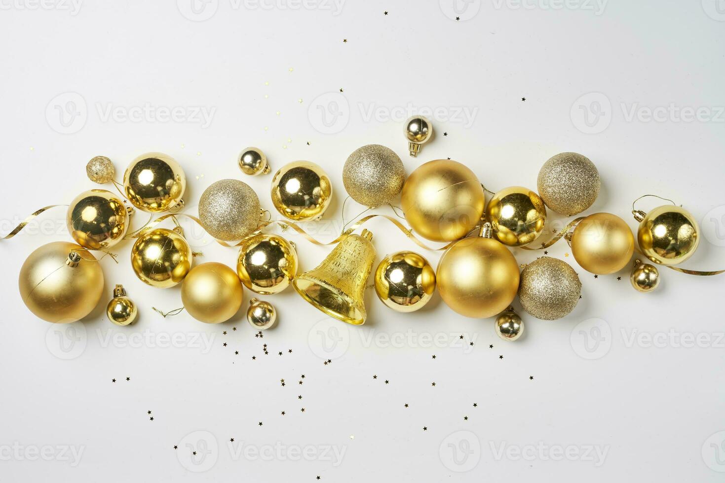 Pile of golden Christmas decorations on white photo