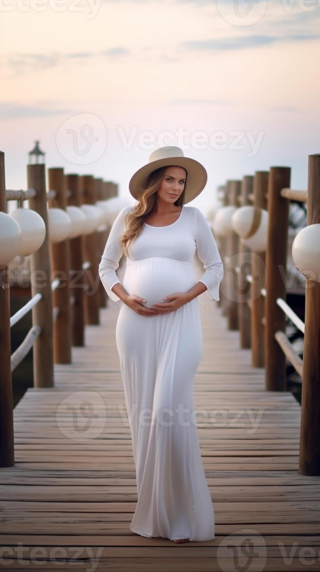 A beautiful pregnant woman in a white dress hugs her pregnant