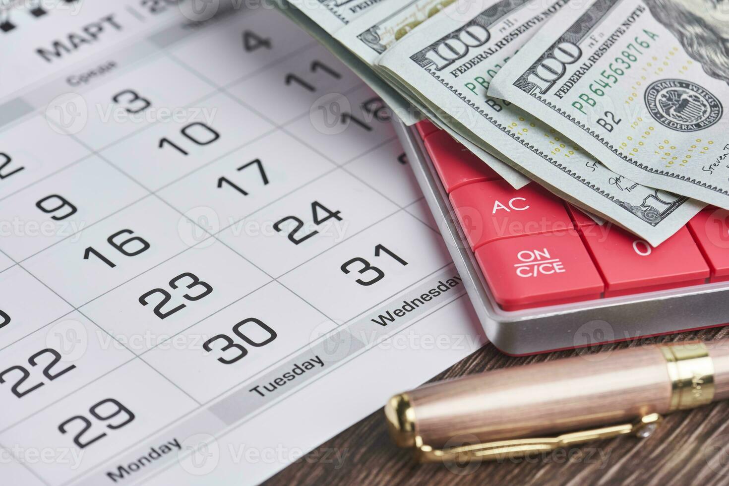 Calculator, us dollars and monthly calendar. Pay day, last day concepts photo