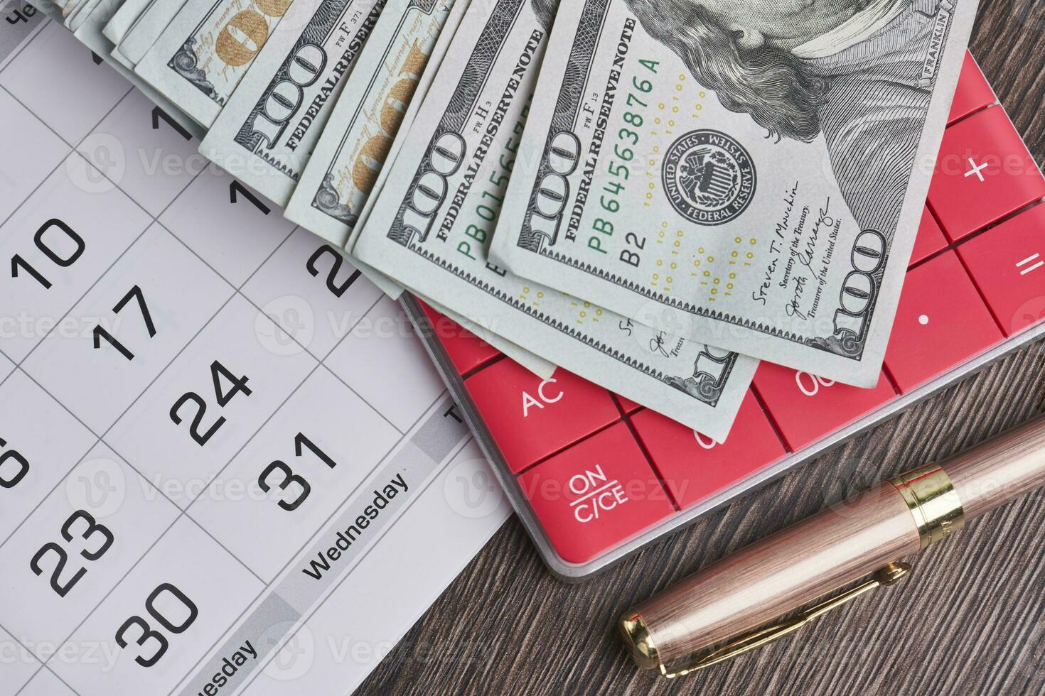 Calculator, us dollars and monthly calendar. Pay day, last day concepts photo