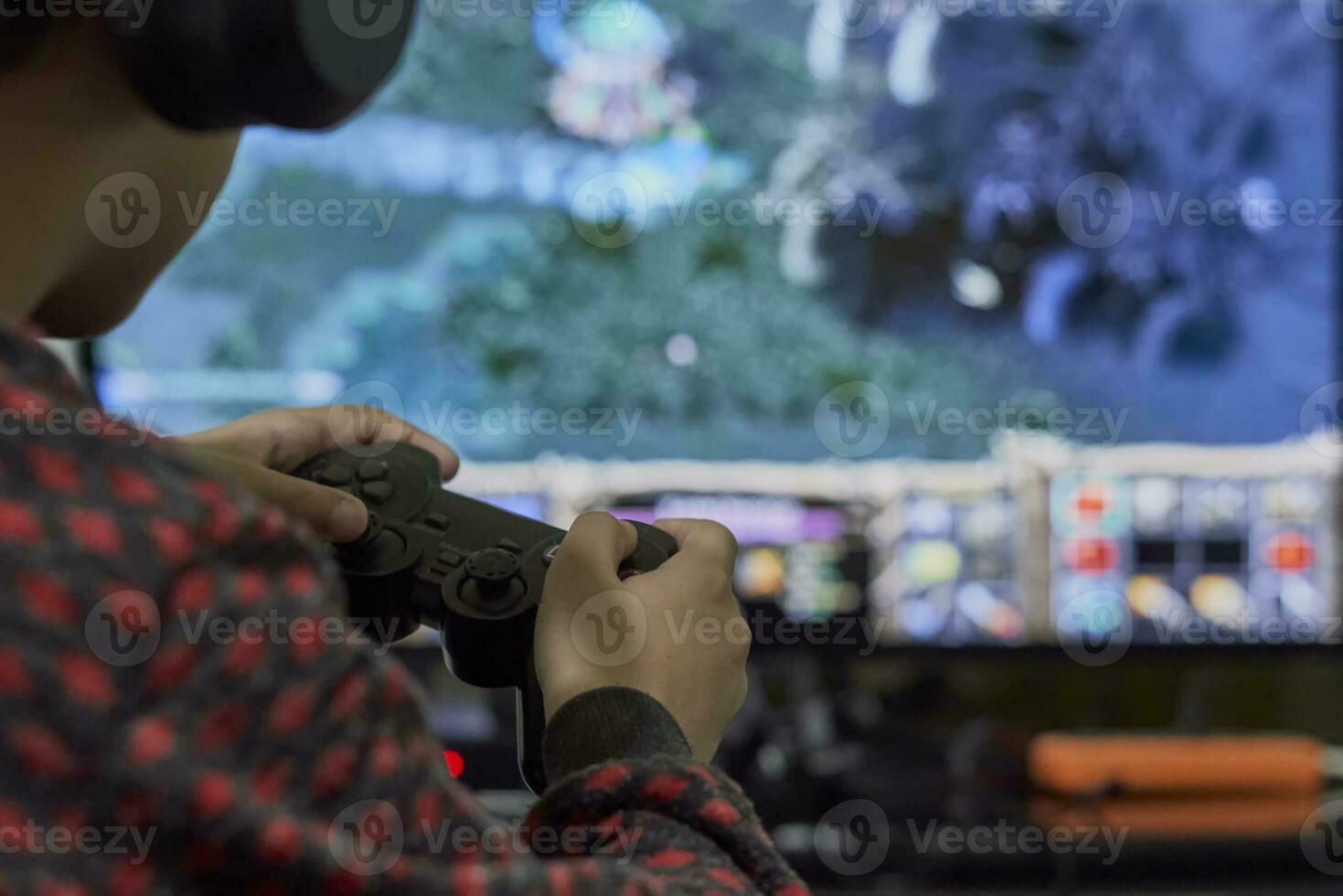 A schoolboy playing strategy on gaming console photo