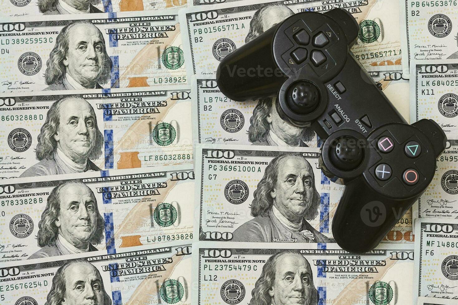 Game console controller and pile of money photo