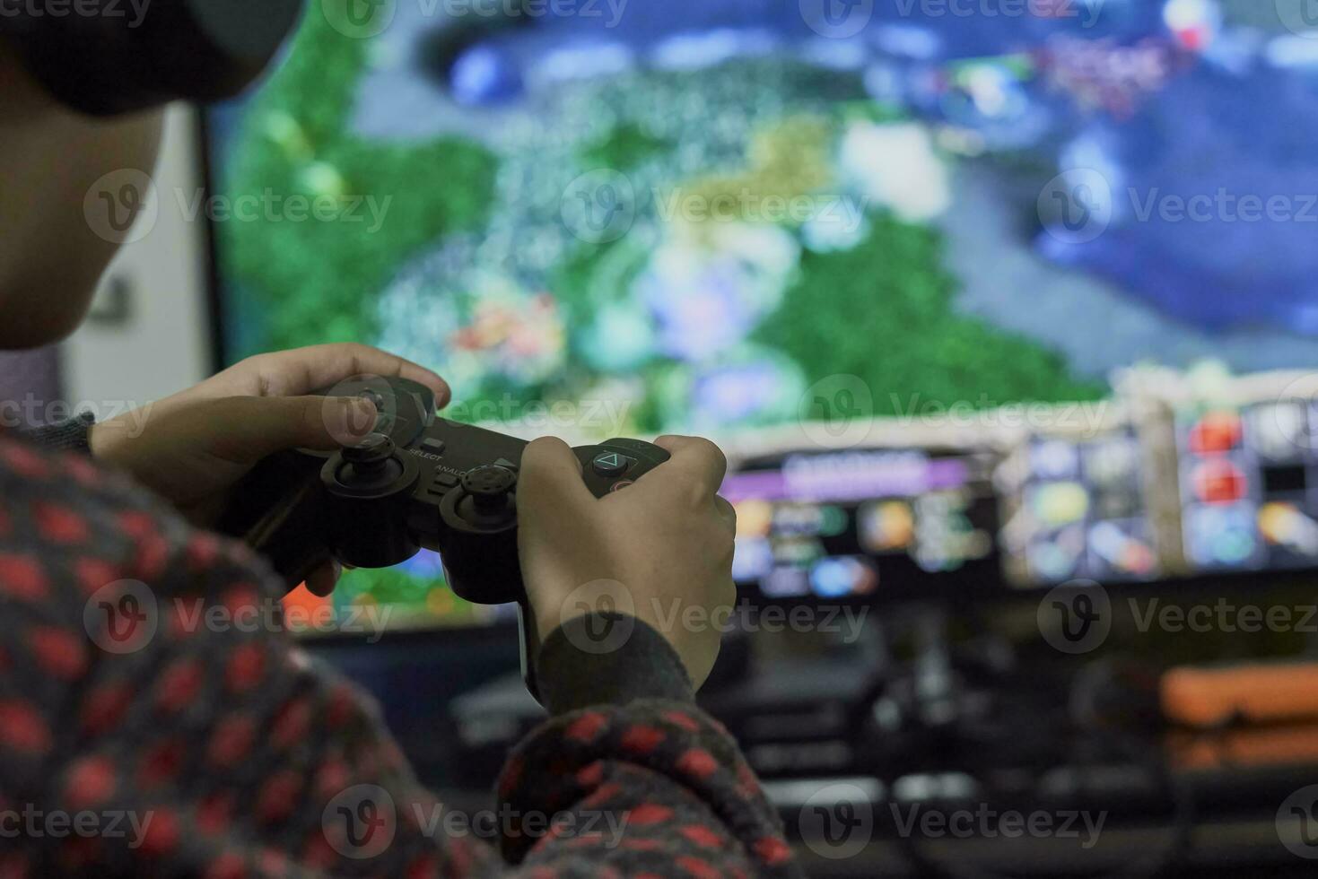 A schoolboy playing strategy on gaming console photo