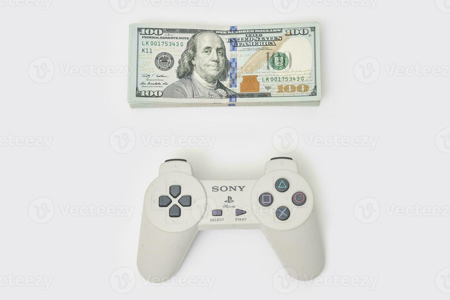 Game console controller and pile of money photo