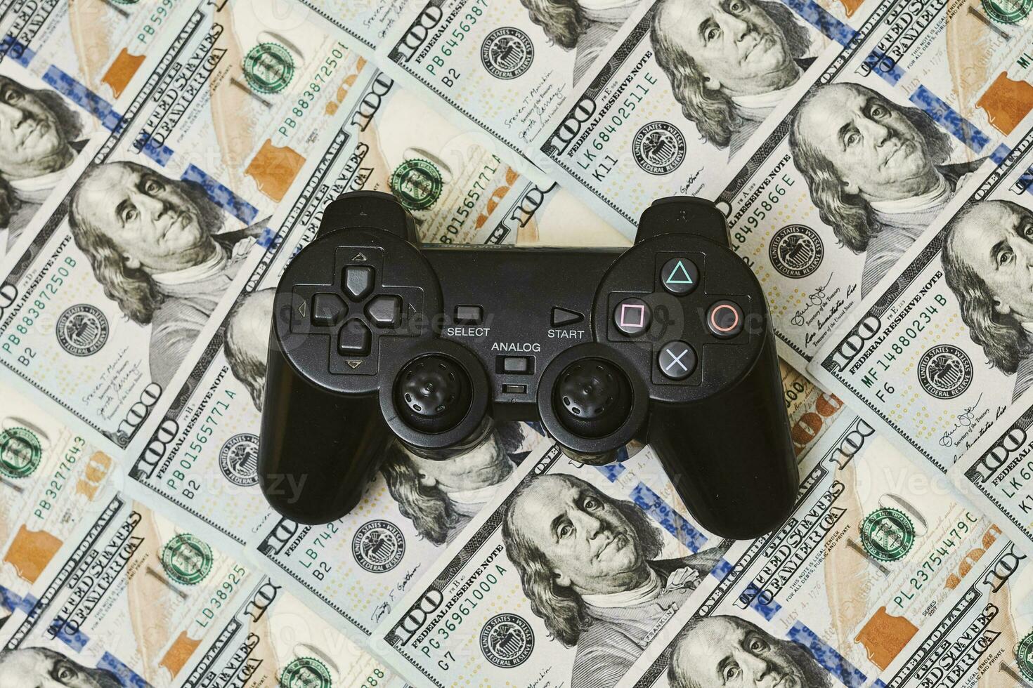 Game console controller and pile of money photo