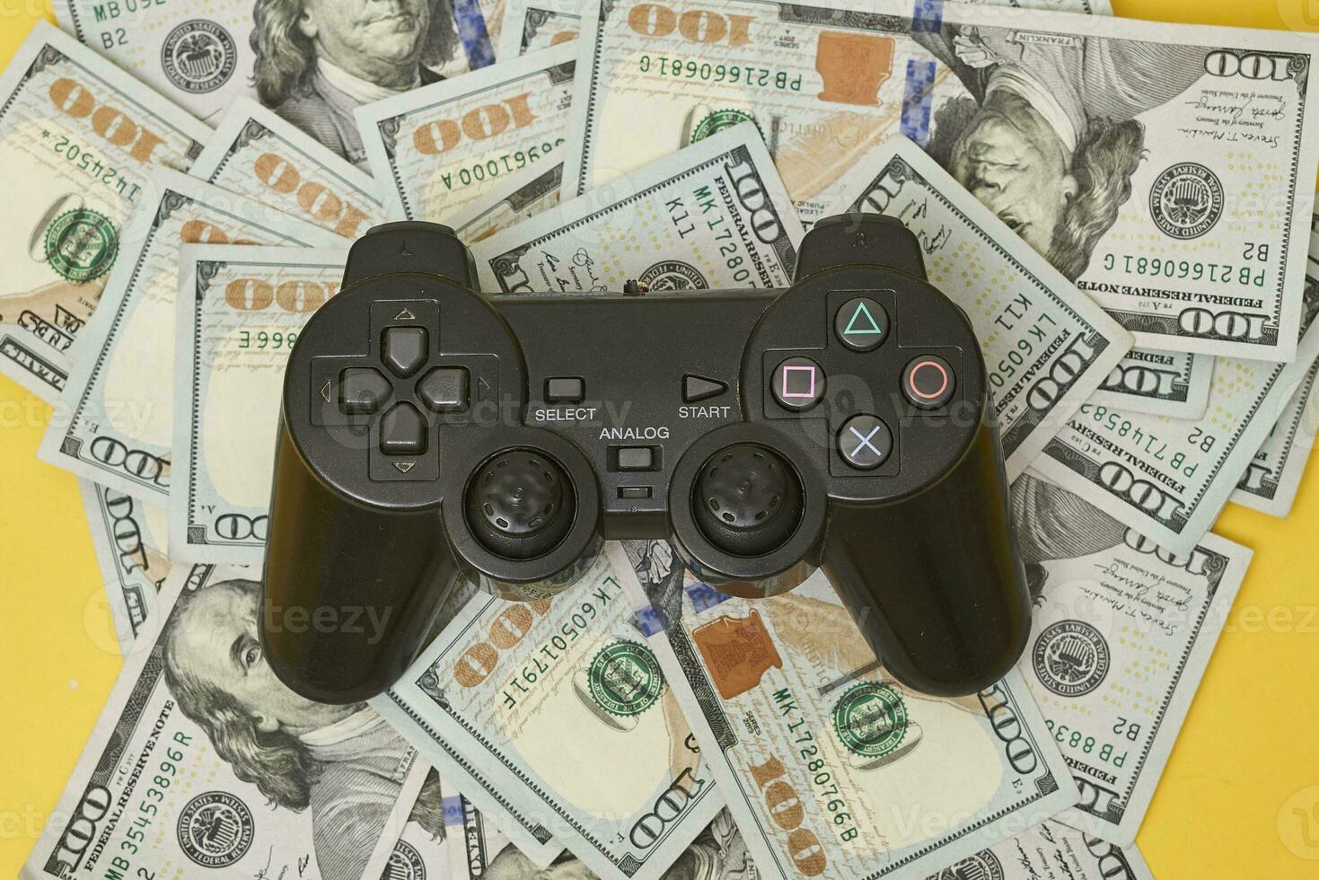 Game console controller and pile of money photo