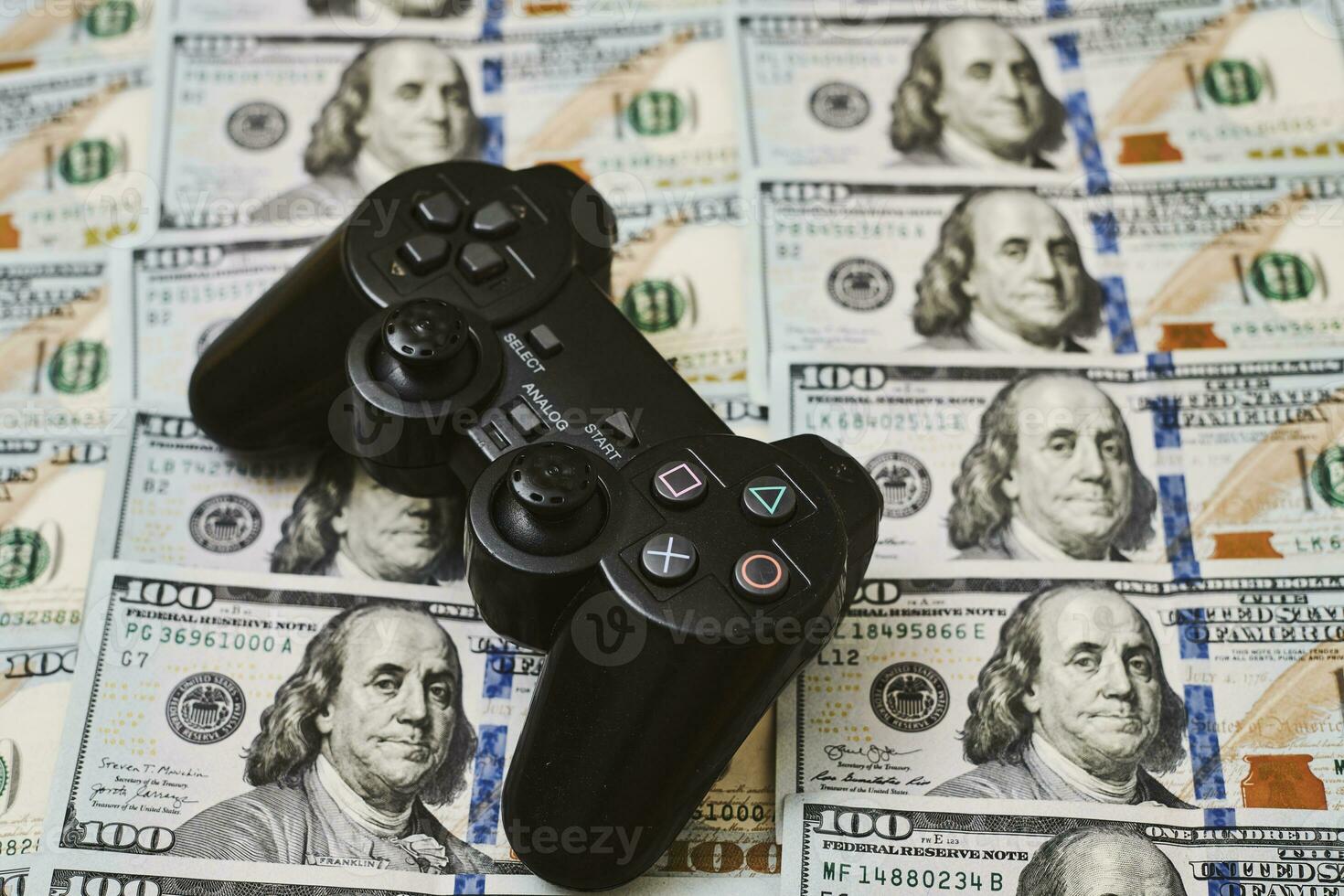 Game console controller and pile of money photo