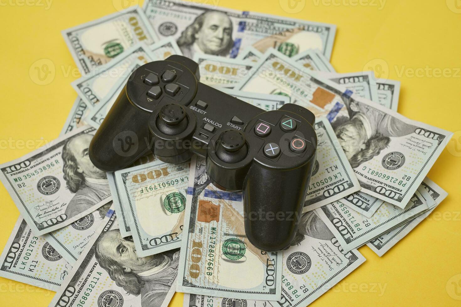 Game console controller and pile of money photo