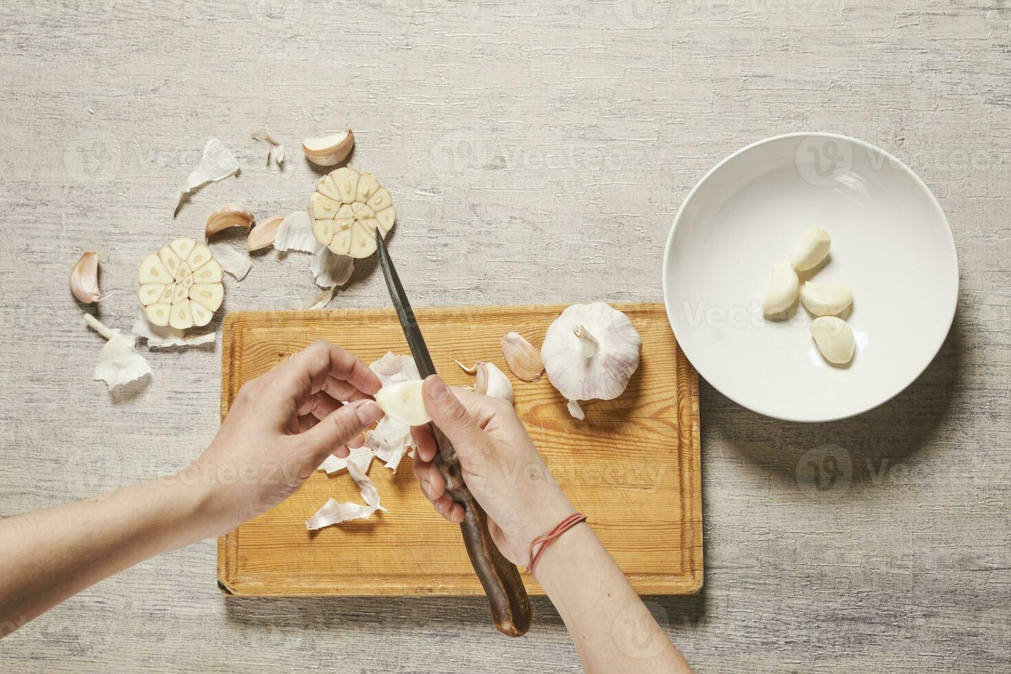 Cleaning organic garlic on cutting board photo