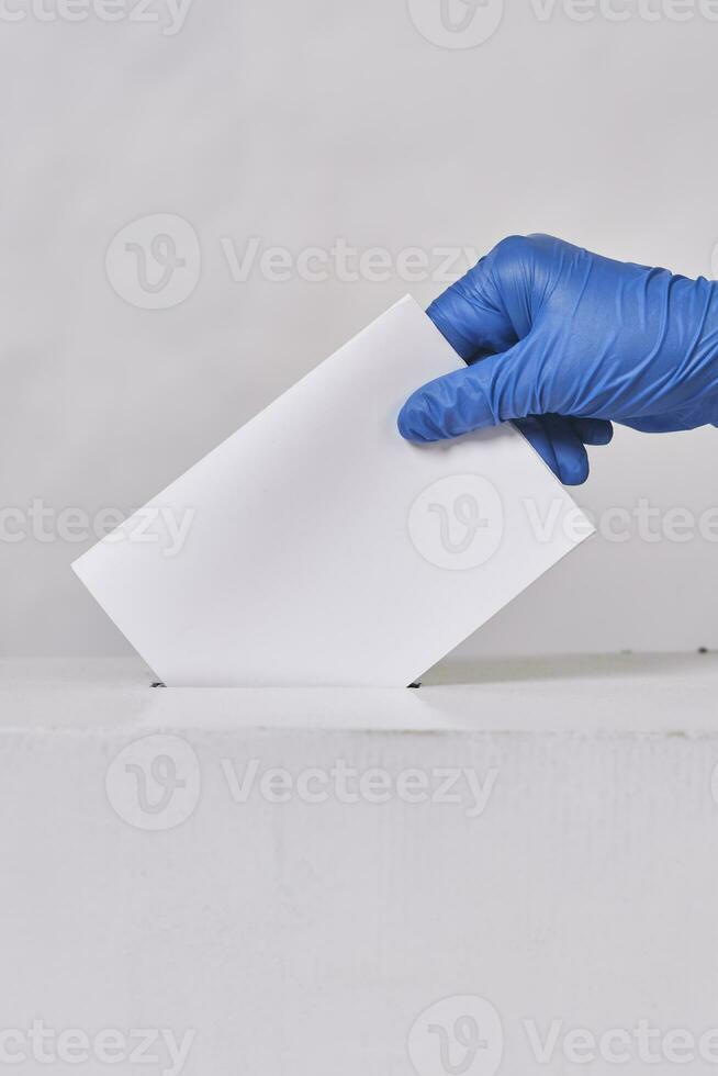 A person in medical gloves voting photo