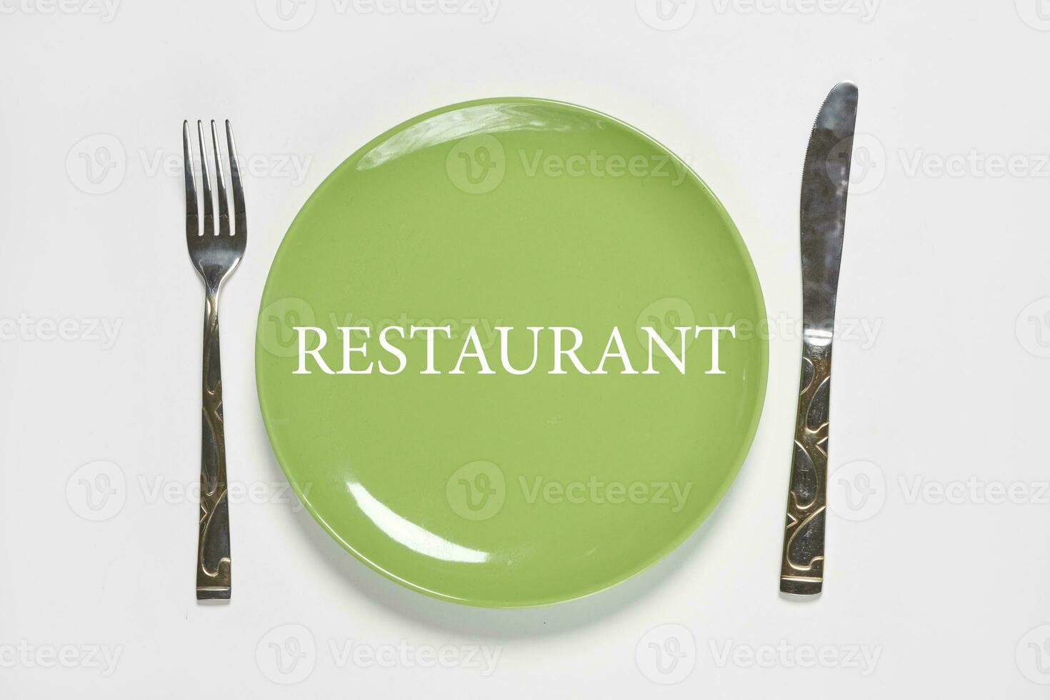 Green plate and fork with kitchen knife photo