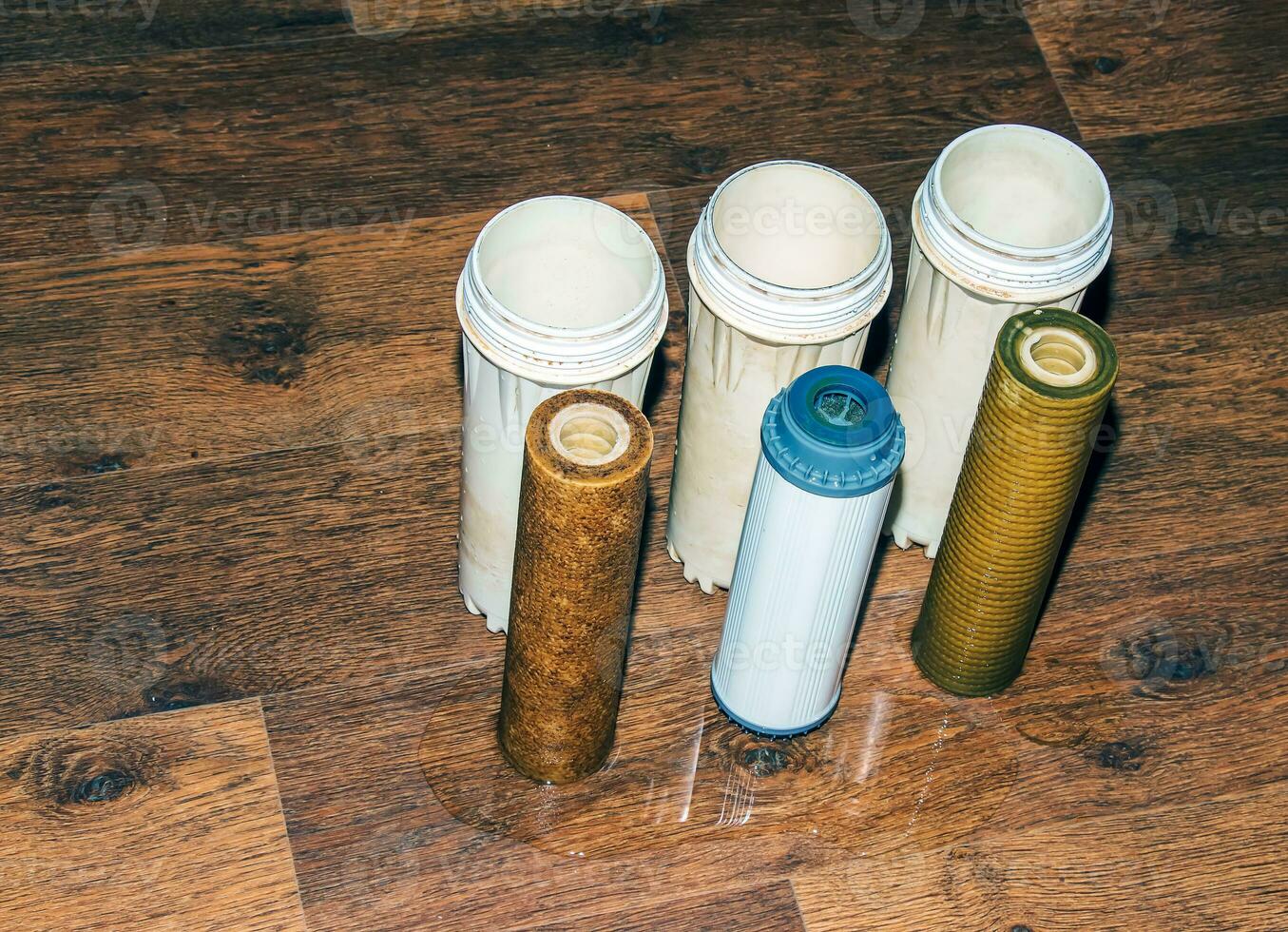 Used water filters with traces of dirt, clay and impurities. Replacing multi-stage water filter cartridges. photo