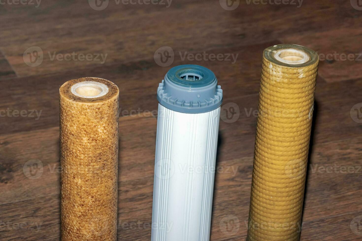 Used water filters with traces of dirt, clay and impurities. Replacing multi-stage water filter cartridges. photo