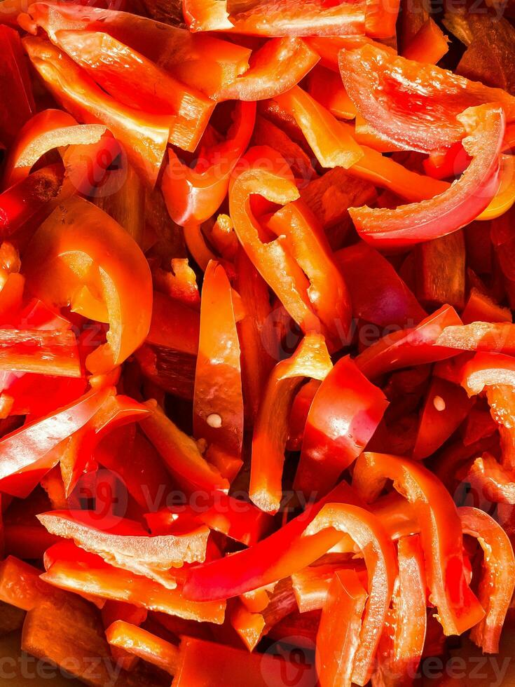 Red fresh bell pepper, sliced. Top view of red cut pepper background. Healthy food concept. photo