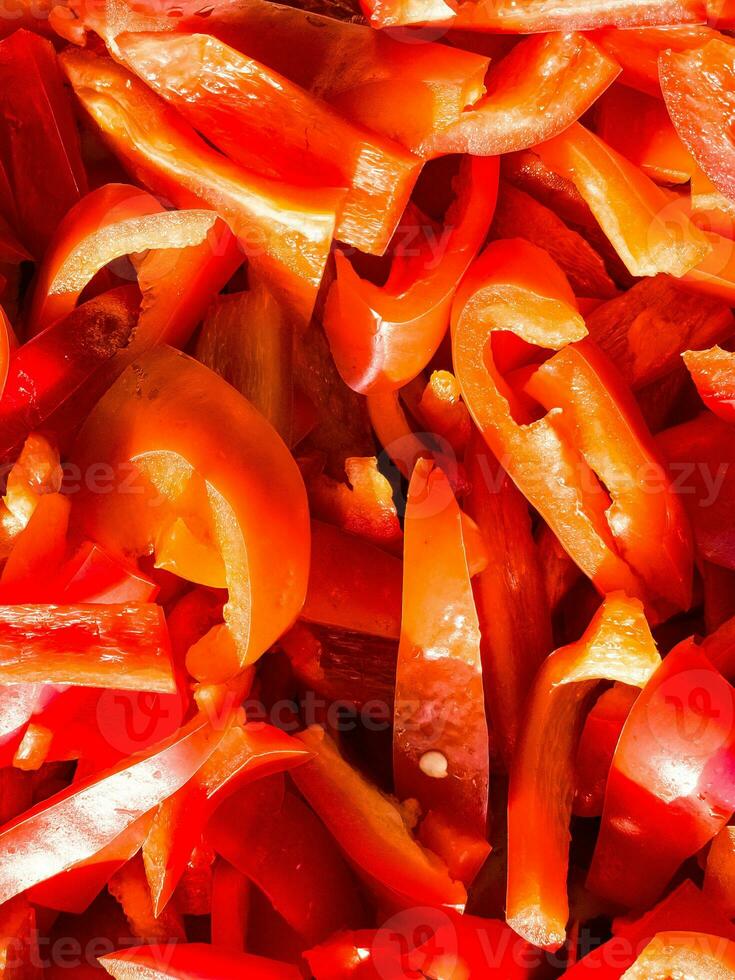 Red fresh bell pepper, sliced. Top view of red cut pepper background. Healthy food concept. photo