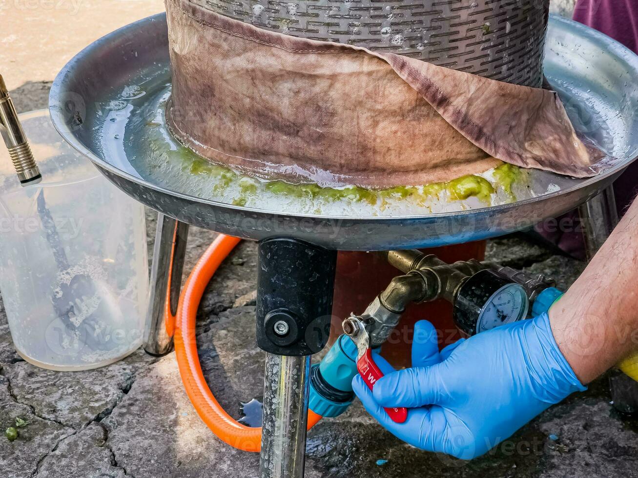 The process of making homemade grape wine. The operation of a hydraulic press to obtain grape juice for fermentation. photo