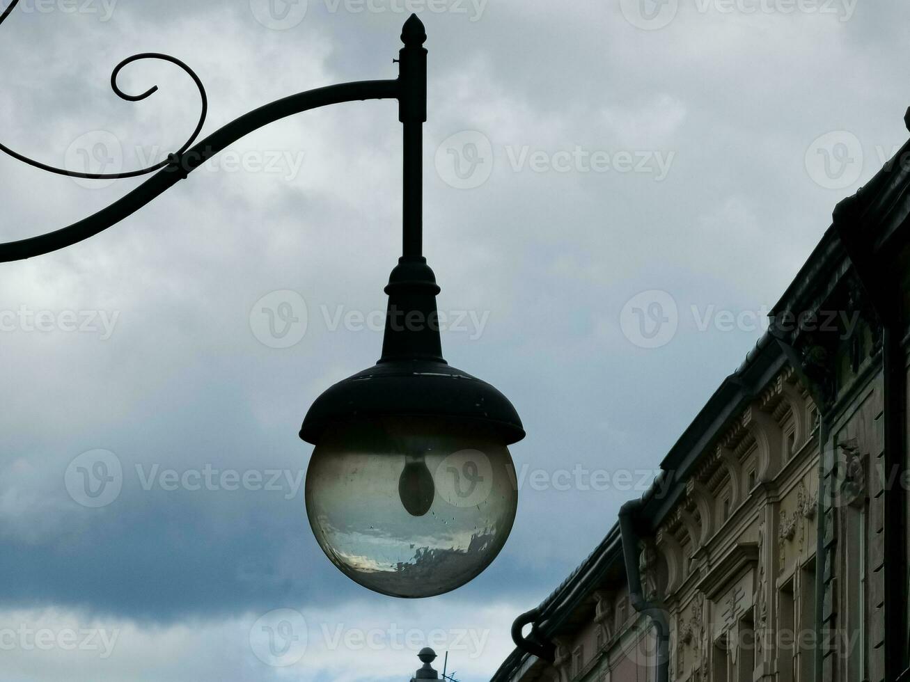 Retro lantern on the background of the blue sky. vintage lantern. A street lantern. Reflection on the surface of the lamp. photo