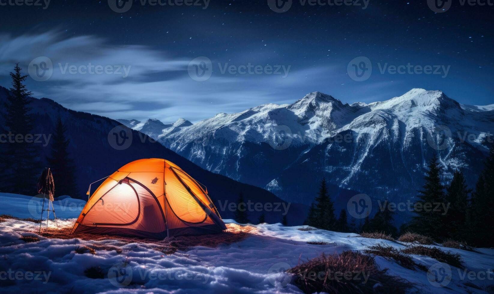 Illuminated tent in snowy mountains under a starry sky. A tranquil