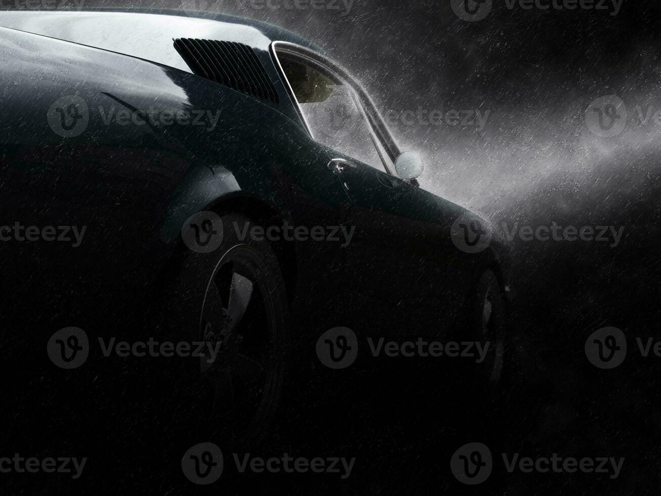Awesome black vintage muscle car in the rain - rear wheel closeup photo