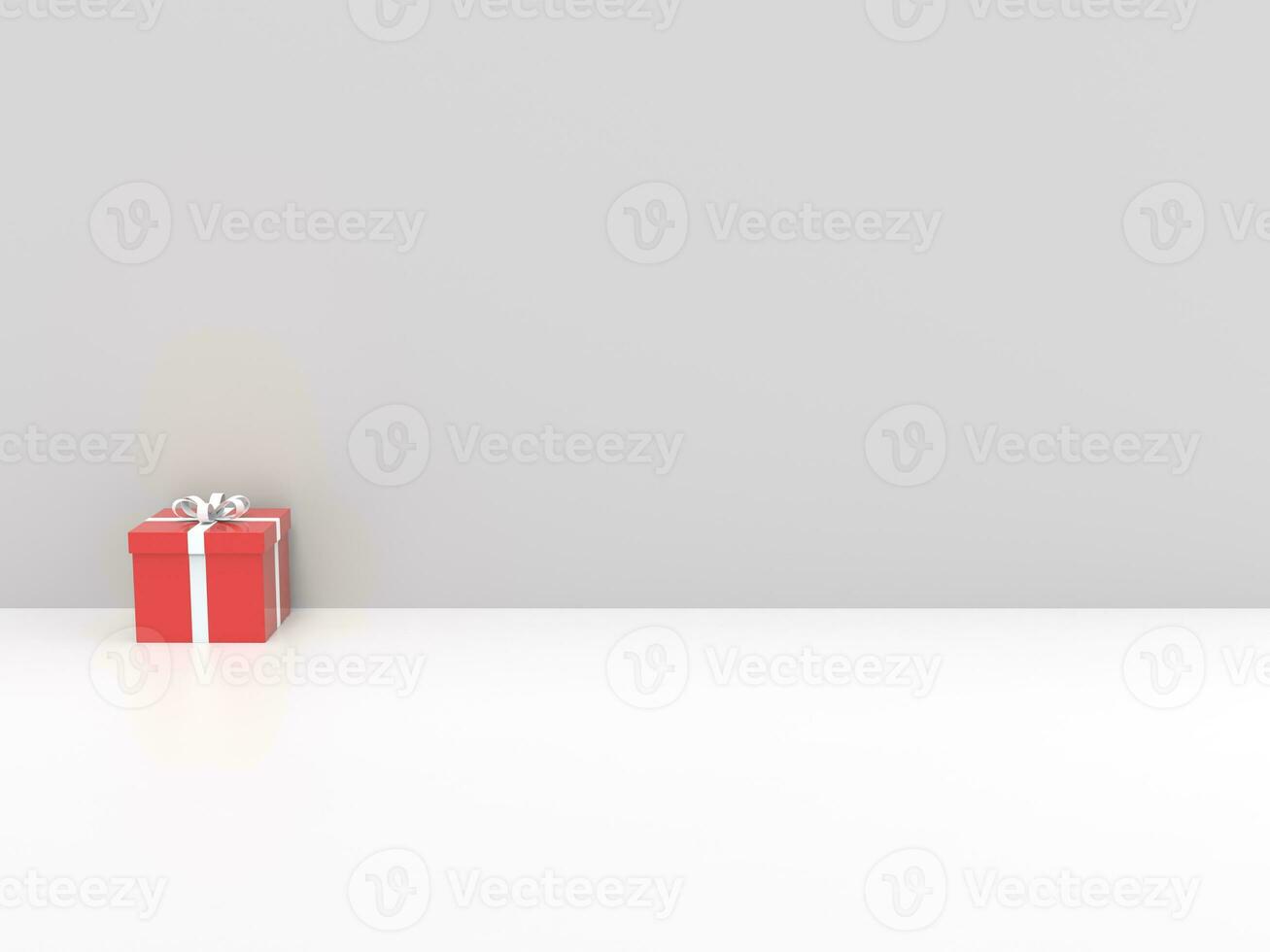 Red Christmas gift box with white ribbon - on white background against white wall photo