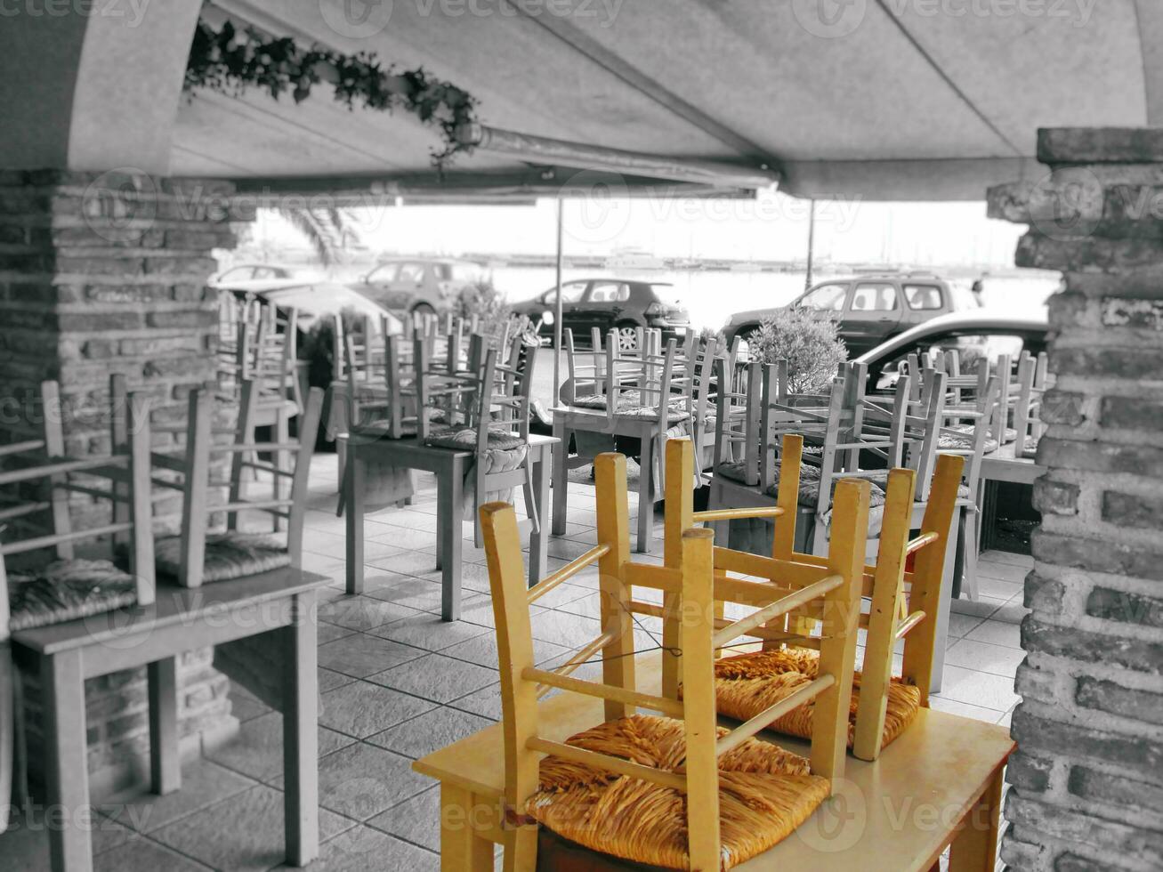 Closed cafe - chairs on tables - black and white photo