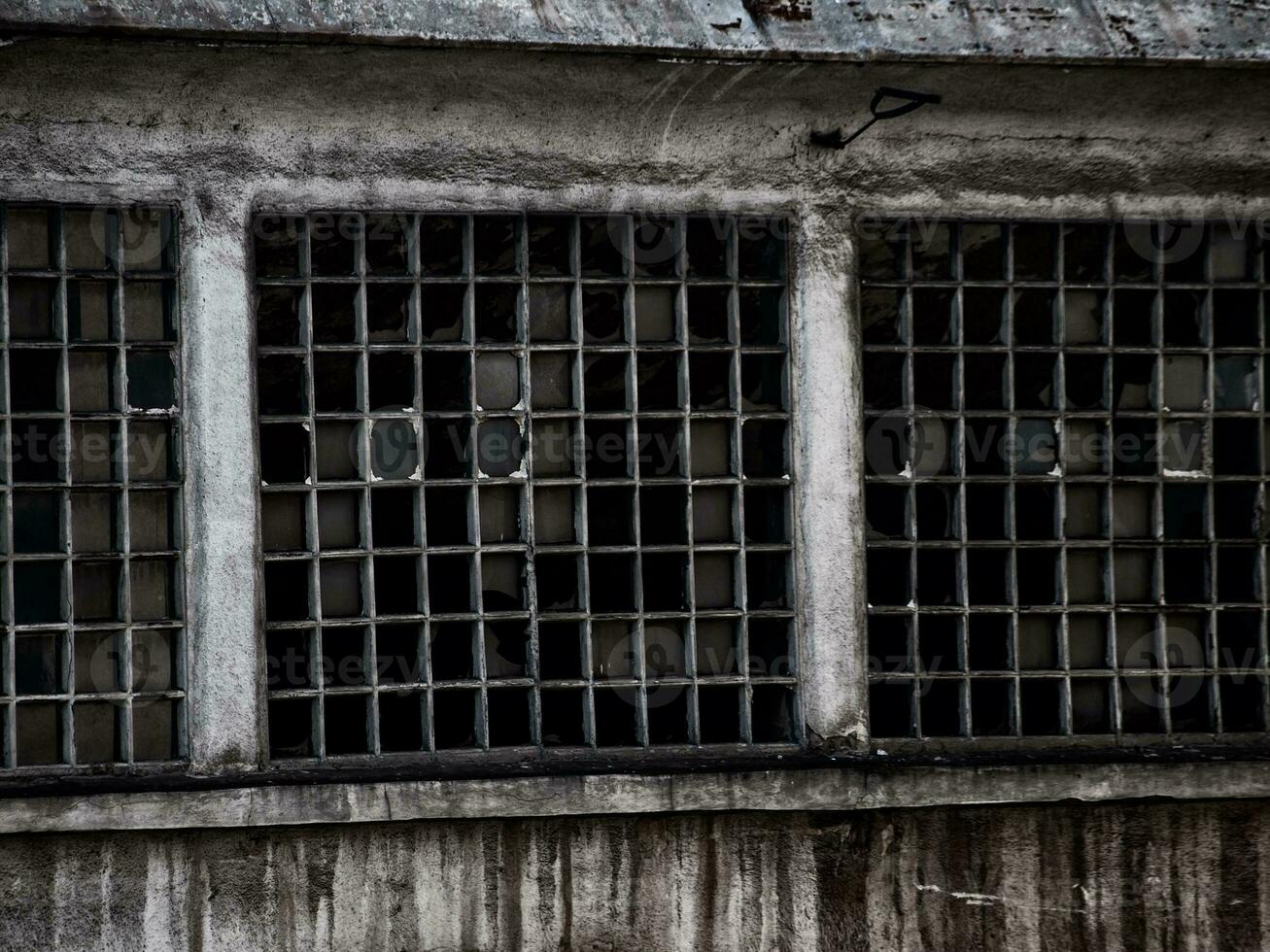 Destroyed factory windows - rust leaking photo