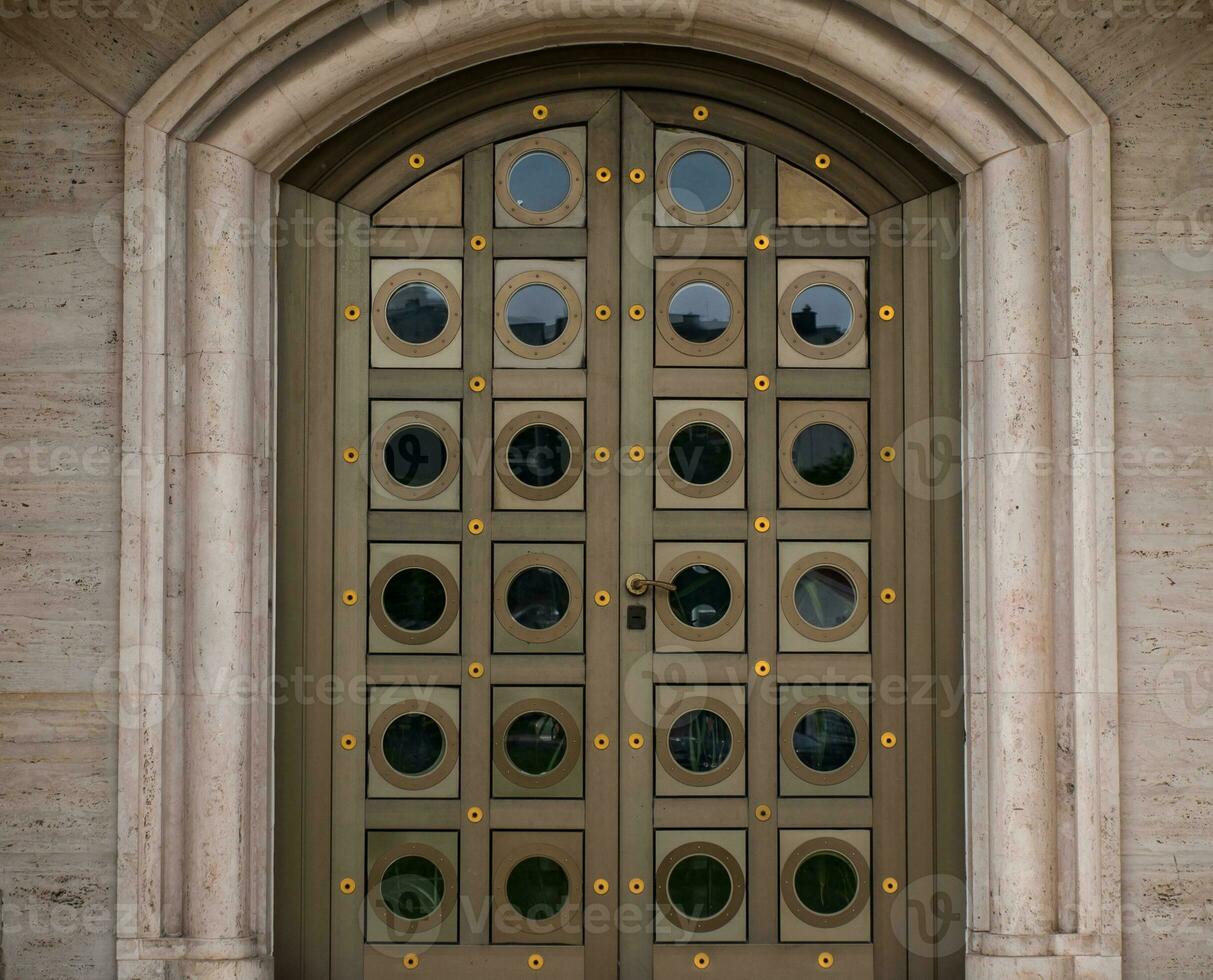 Modern metal door on the stone building photo