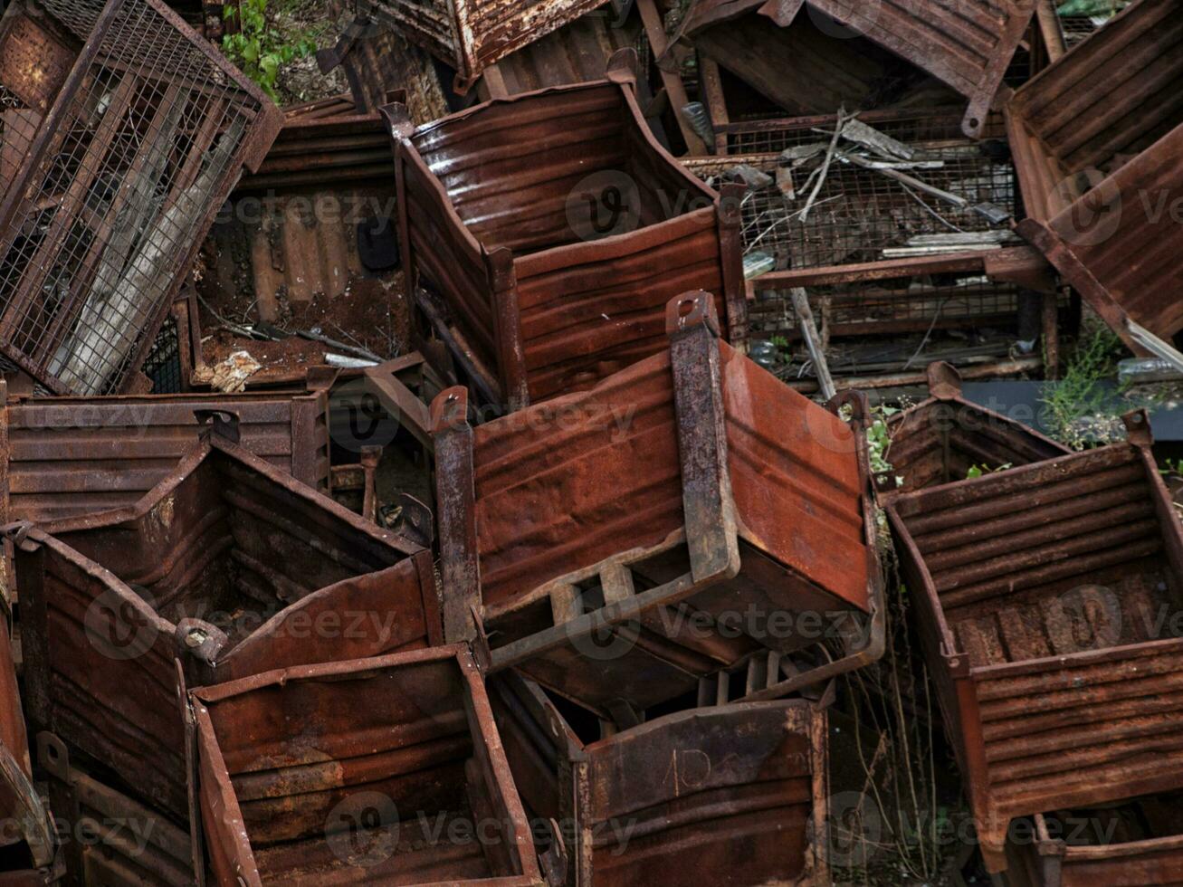 Heap of discarded rusty metal storage boxes photo