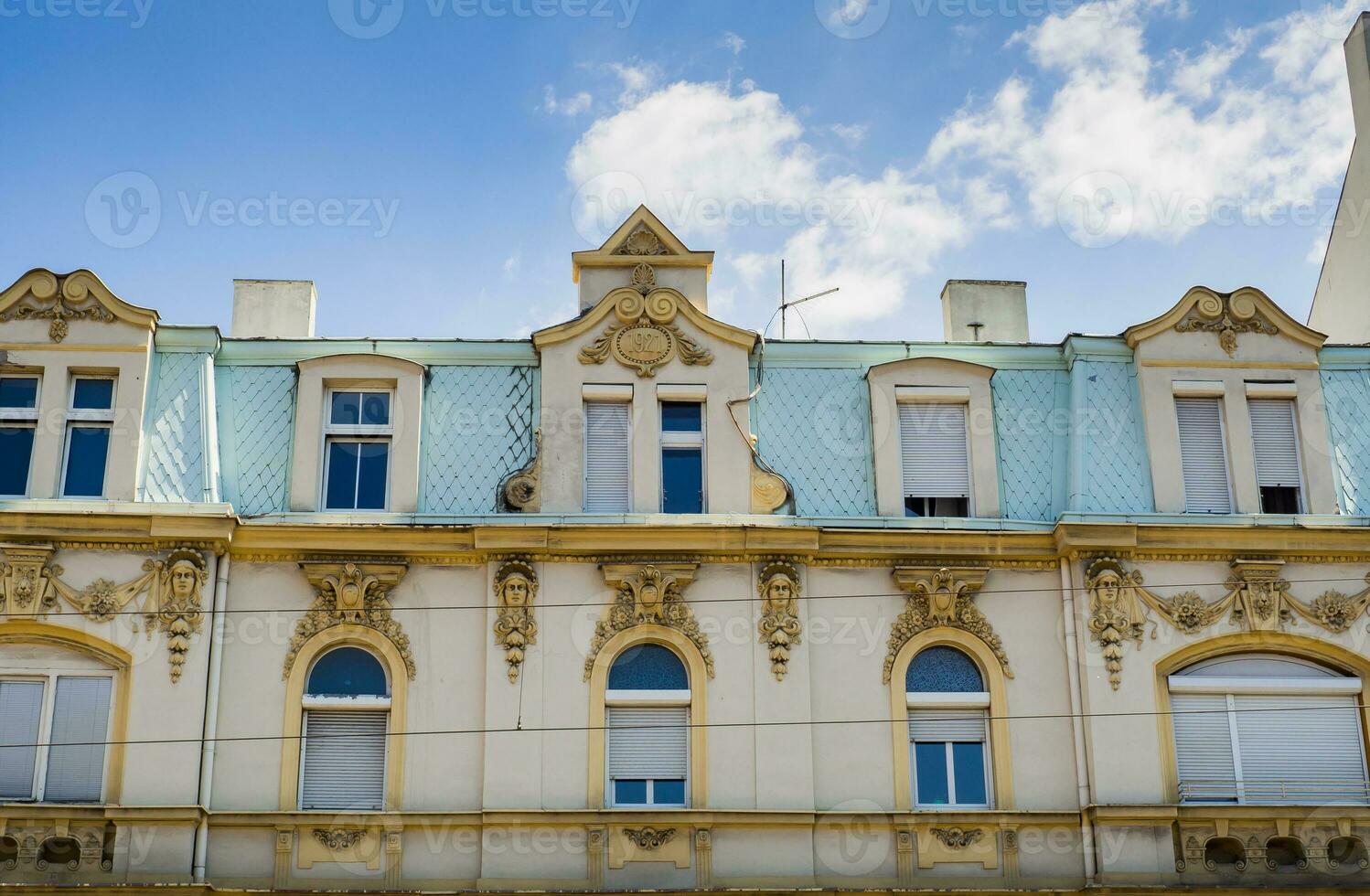Beautiful old building with stunning facade decorations and sculptures photo