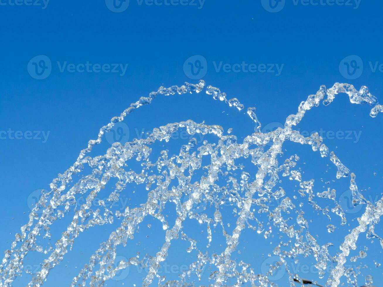 Water drops shooting up from the fountain photo