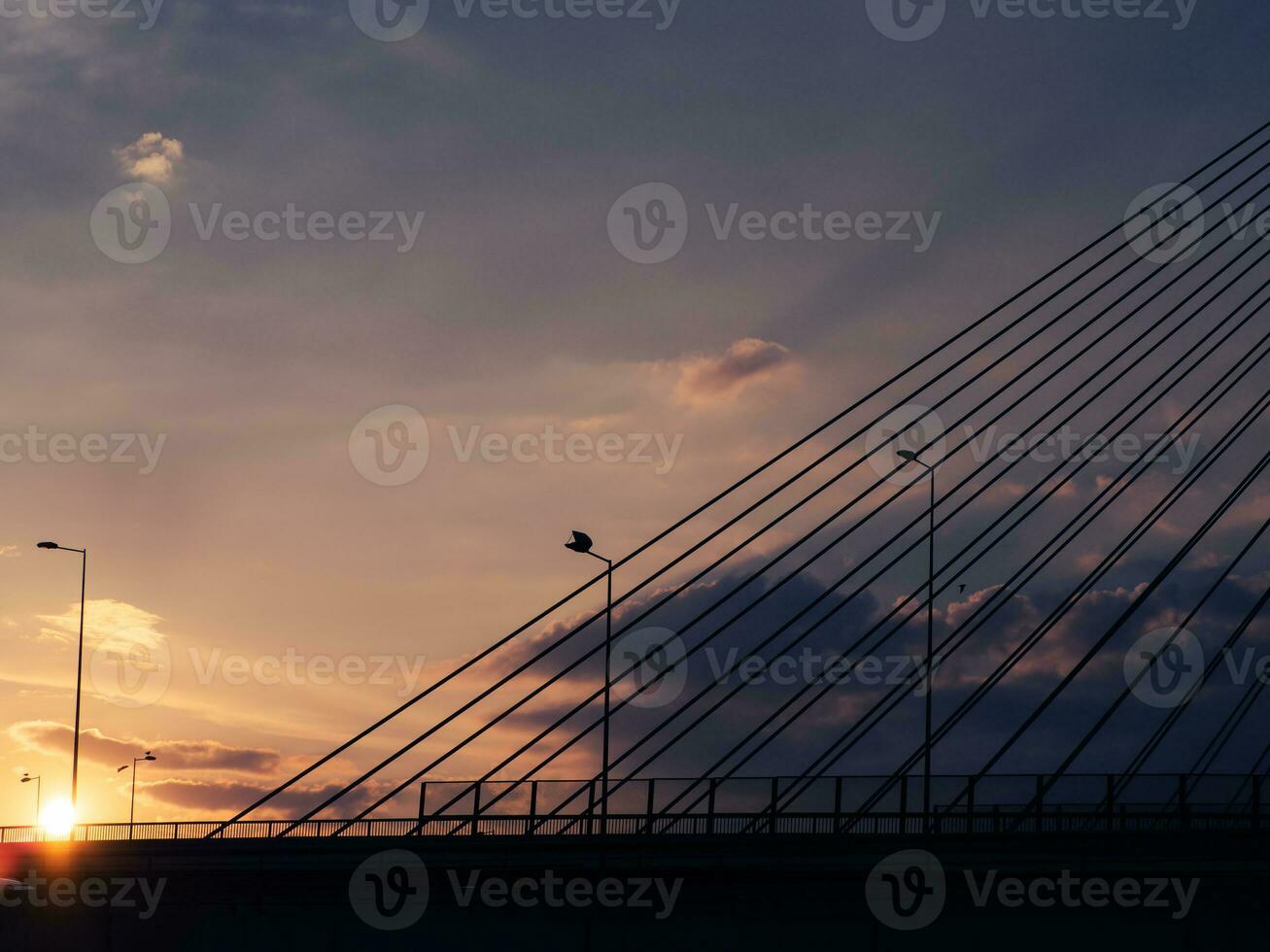 Sunset over the big suspension bridge and highway photo