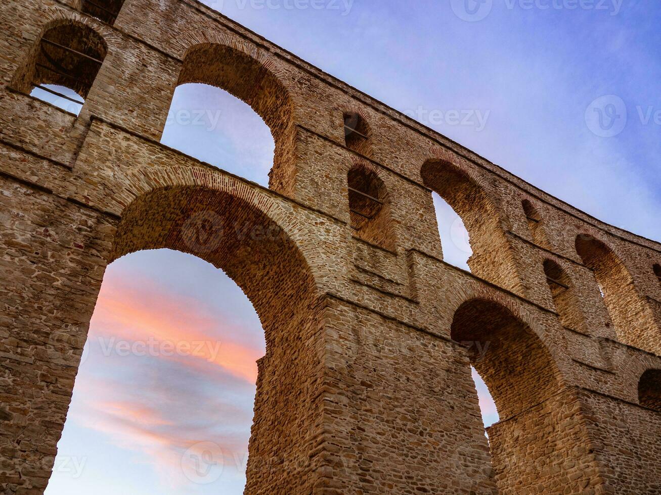 Ancient Roman aqueduct structure - sunset shot photo