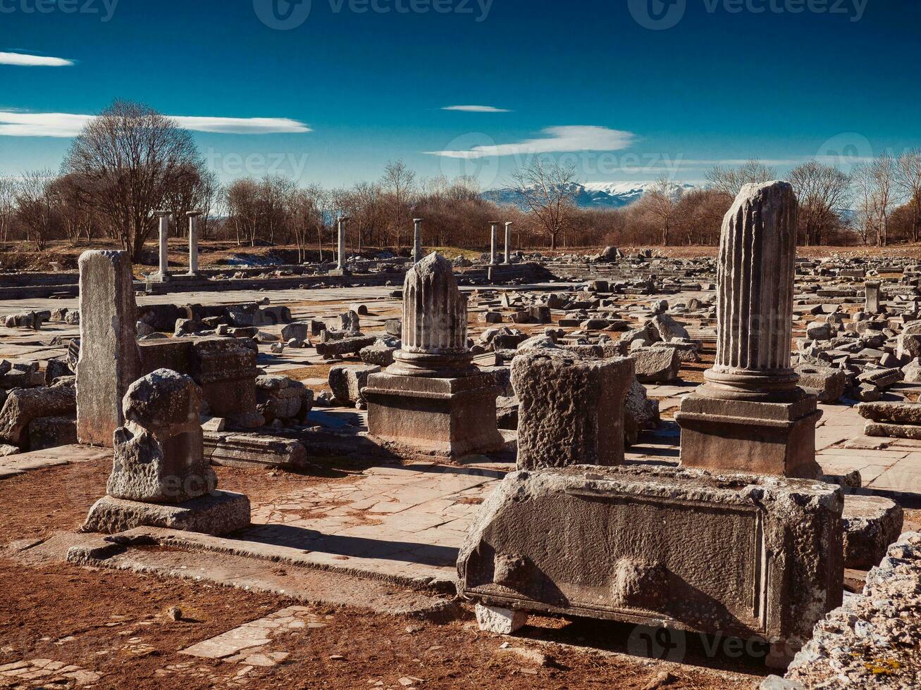 Ancient Greek ruins, stone slabs, columns and building foundations at Philippi, Greece photo