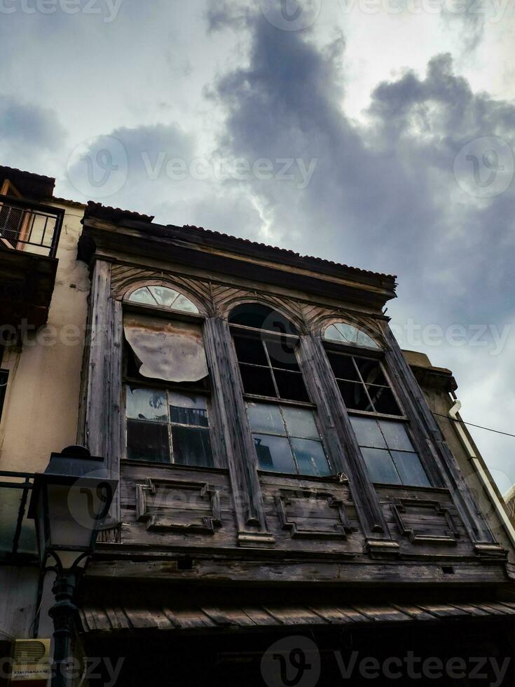 Abandoned old house in the old part of town - storm clouds looming above photo