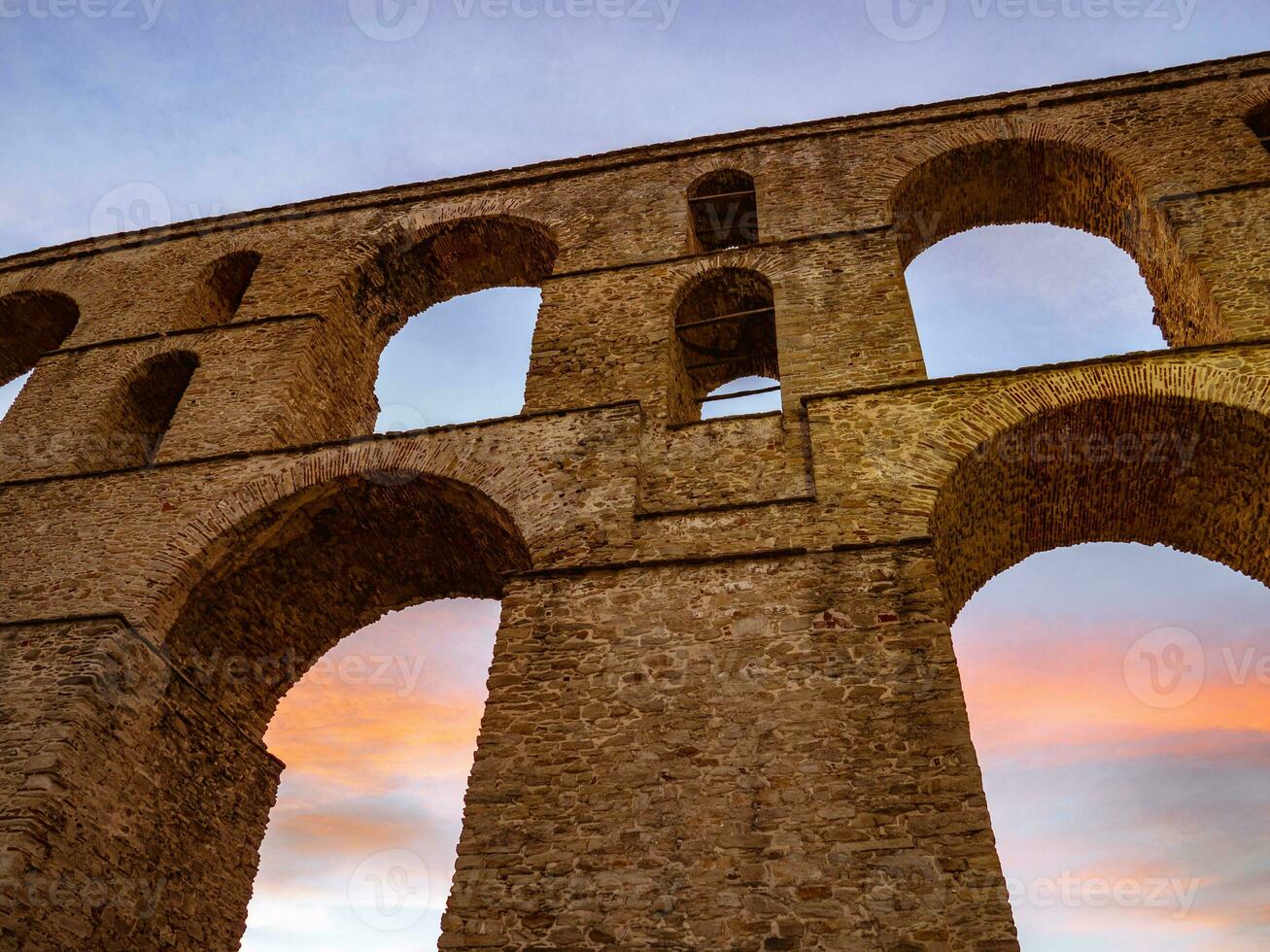 Ancient roman aqueduct in the sunset photo