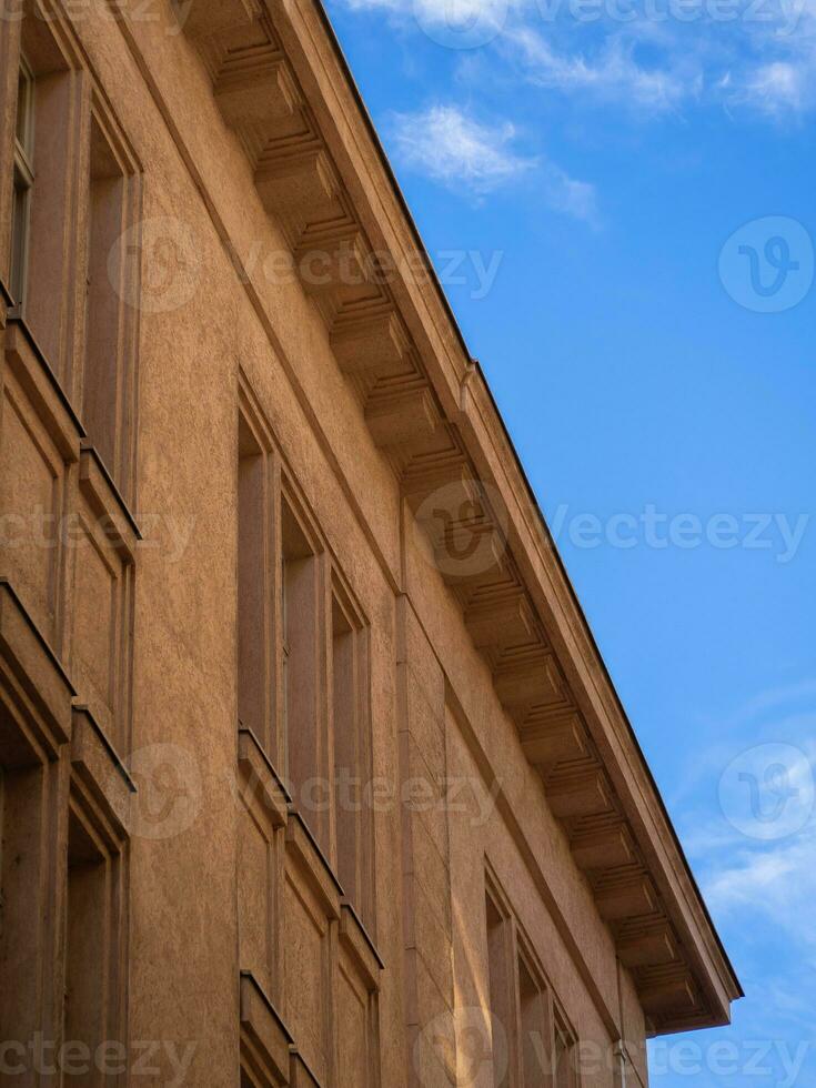 Beutiful facade of a old building creating color contrast against blue sky photo