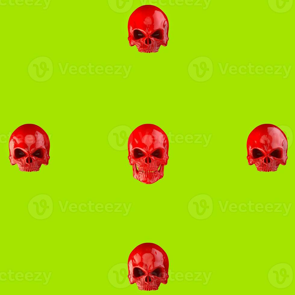 Red skulls on bright green background photo