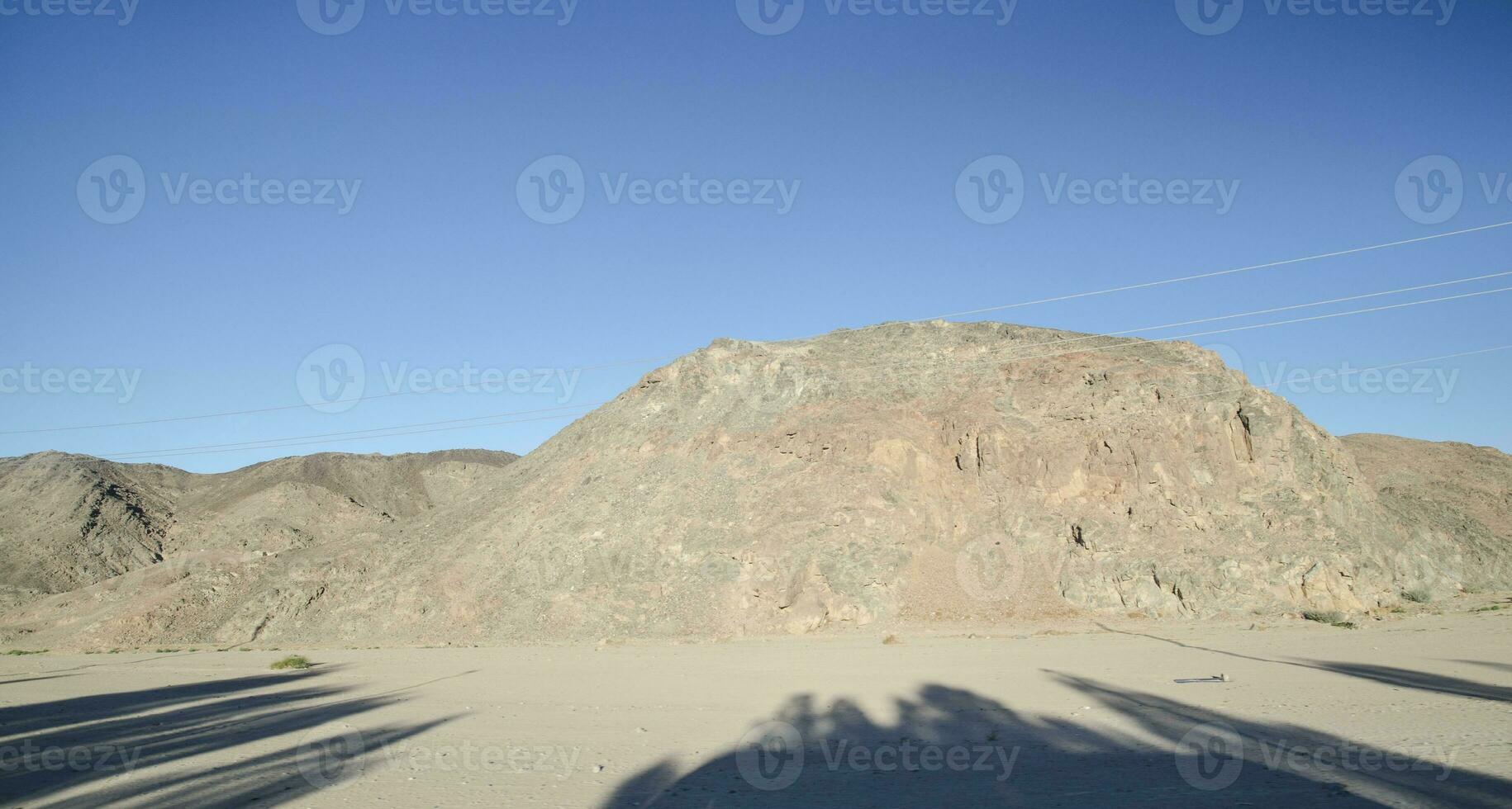 Sahara rocks and hills with trees shadows photo