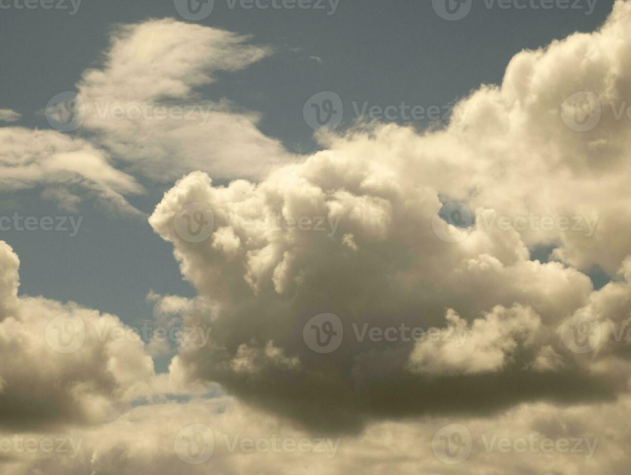 White clouds over sunset summer sky background. Fluffy cumulus clouds shape photo