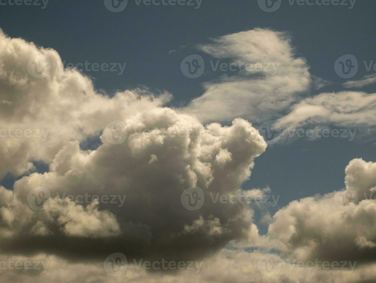 White clouds over sunset summer sky background. Fluffy cumulus clouds shape photo