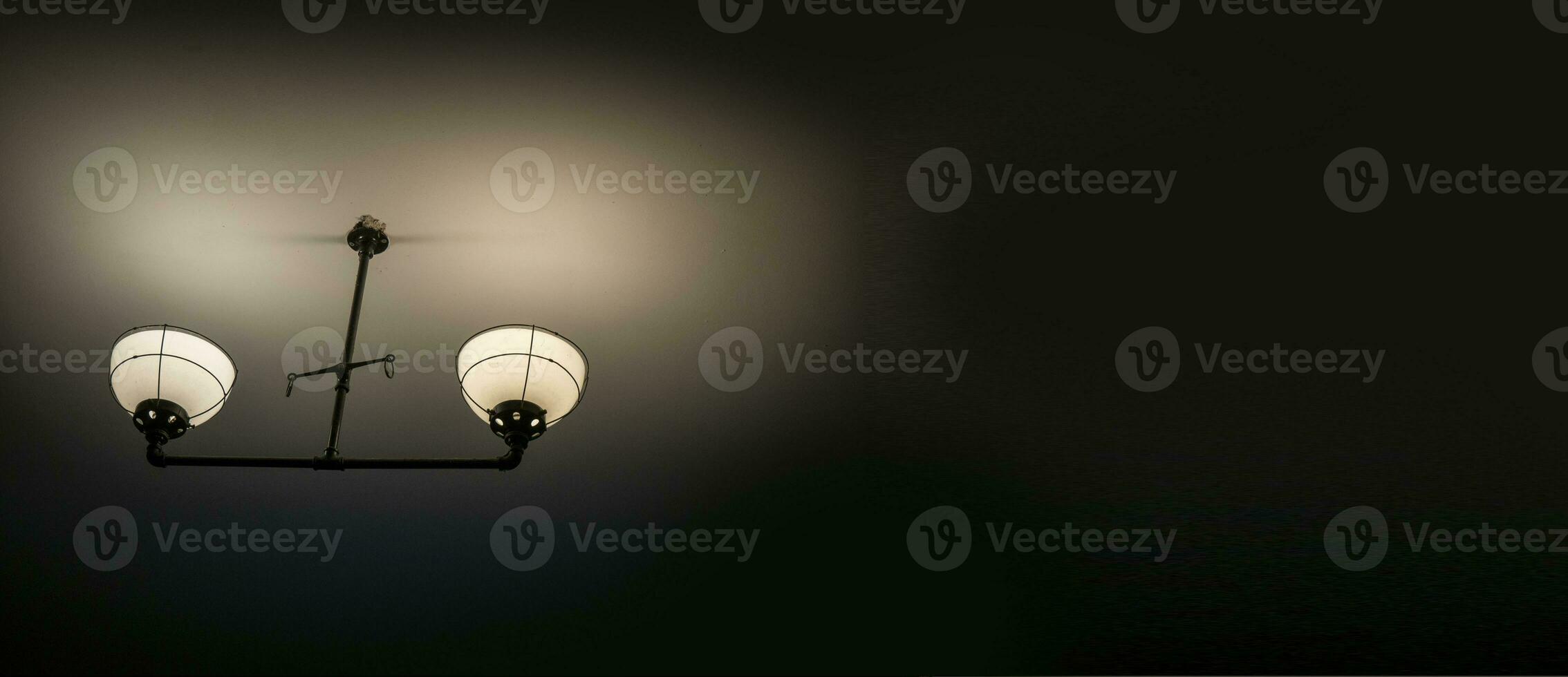Old ancient lamps on the wall in a dark room background, gloomy light photo