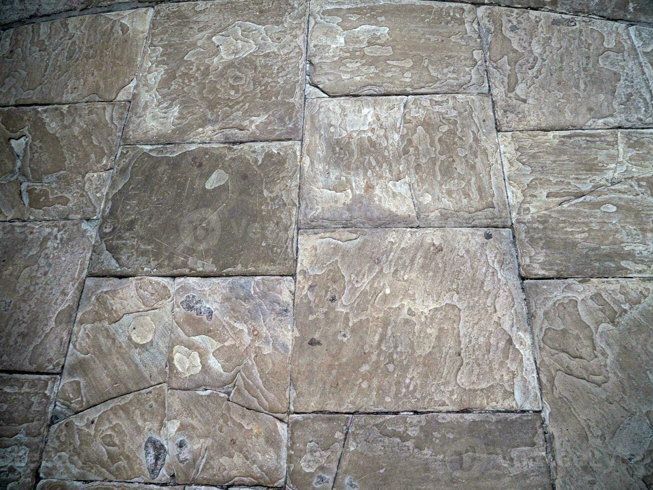 Old stone wall pattern close view background, ancient bricks surface photo