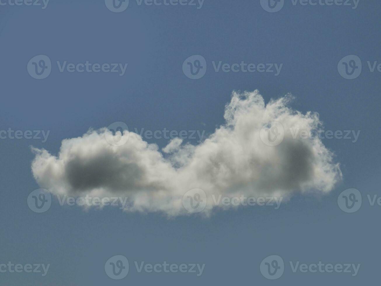 Single white cloud over blue sky background. Fluffy cumulus cloud shape photo