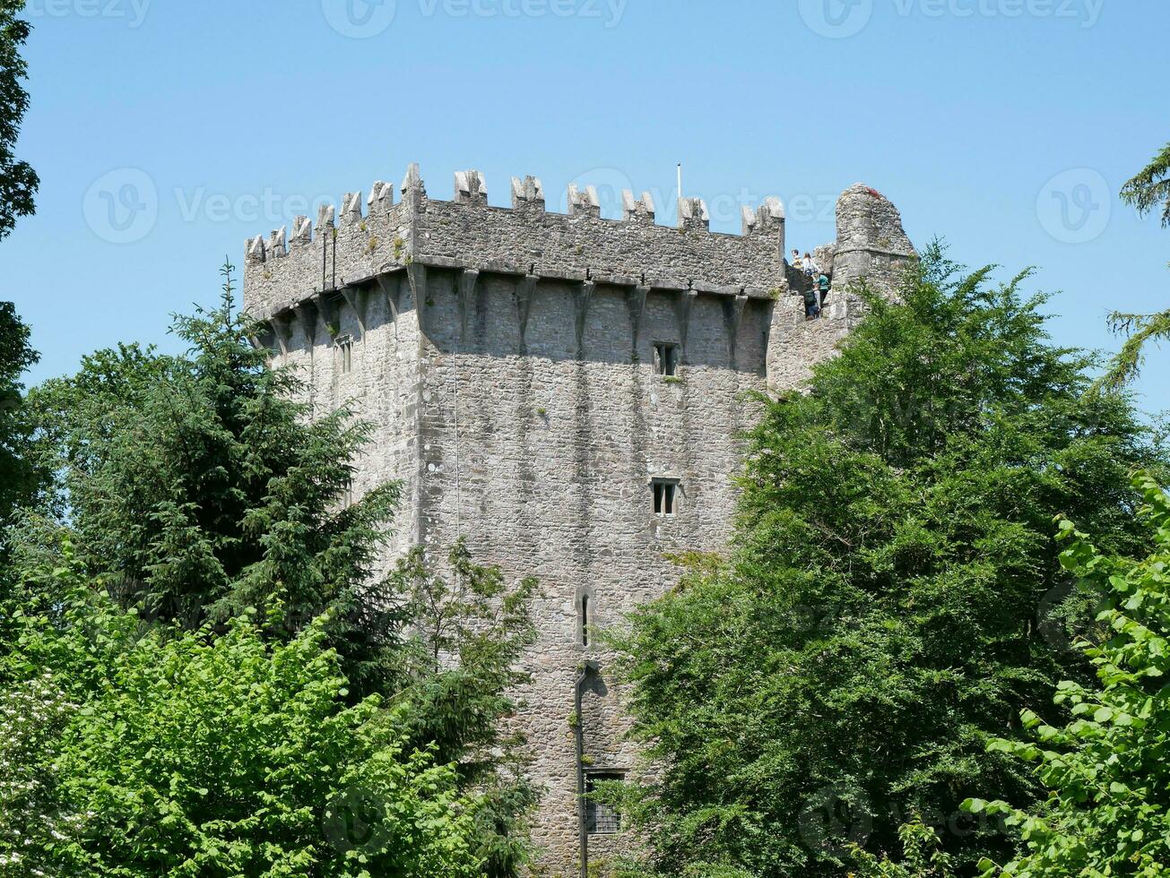 Old celtic castle tower in the trees, Blarney castle in Ireland, old ancient celtic fortress photo