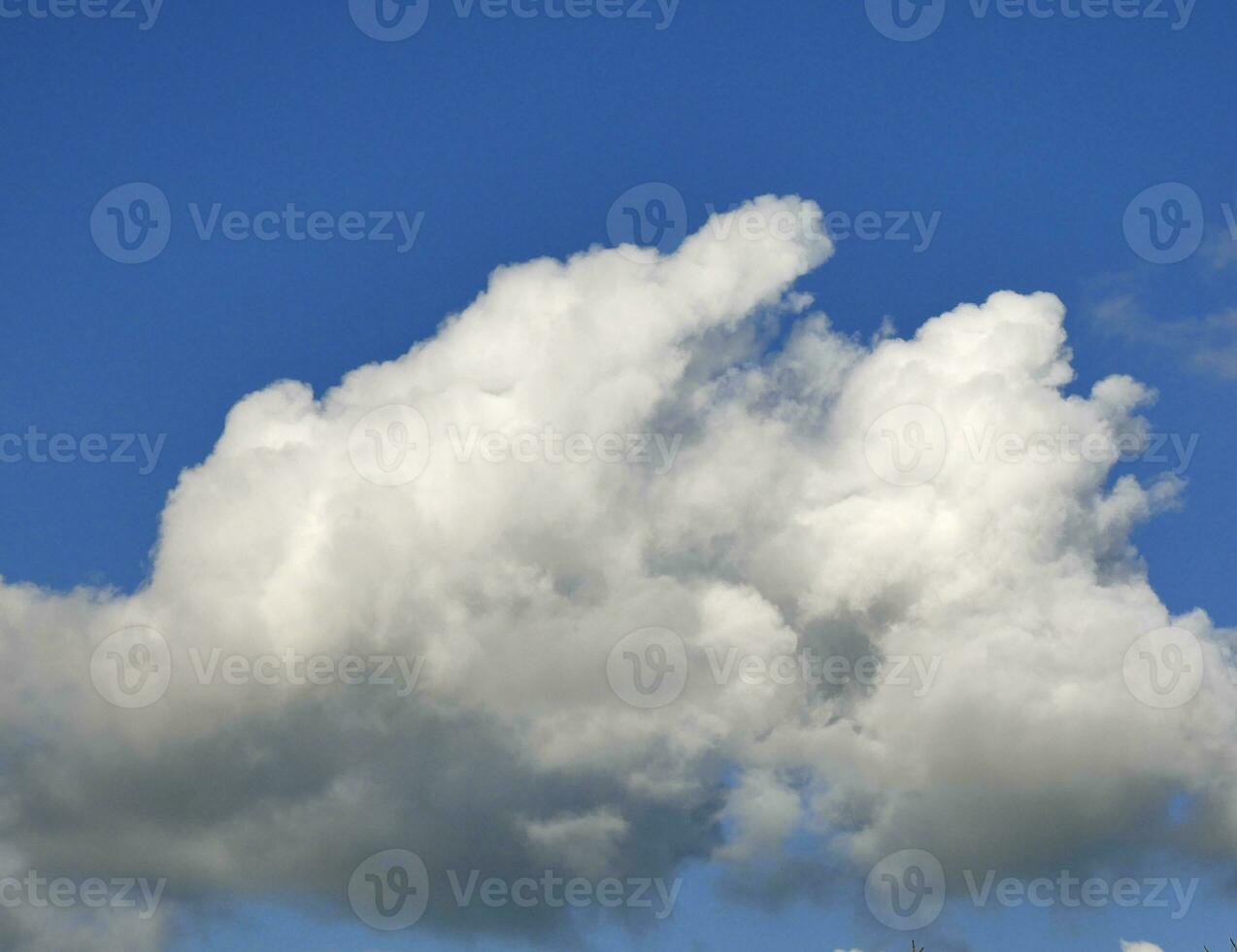 White and grey cumulus clouds background over the blue summer sky background photo