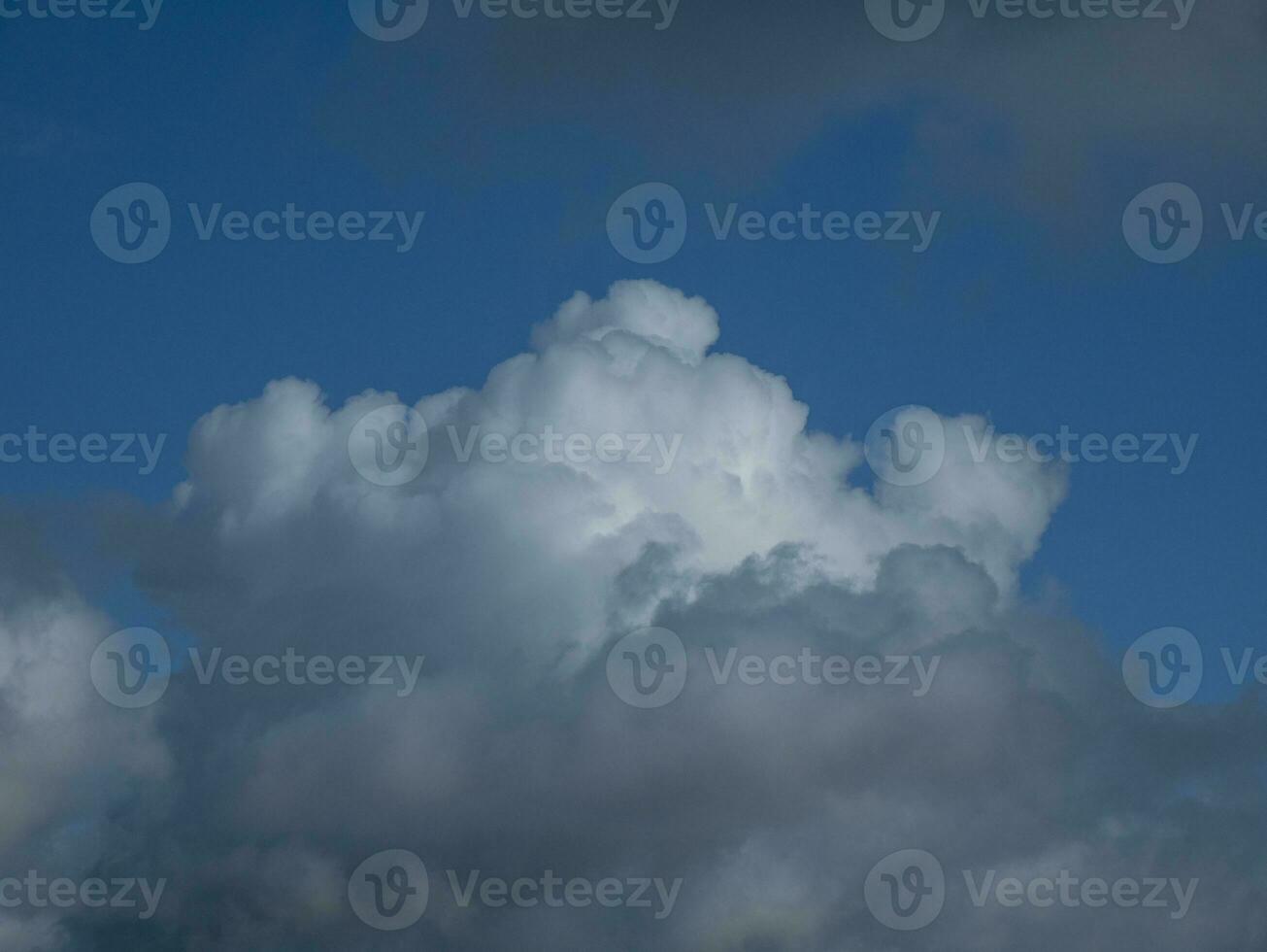 White fluffy clouds in the stormy sky background photo
